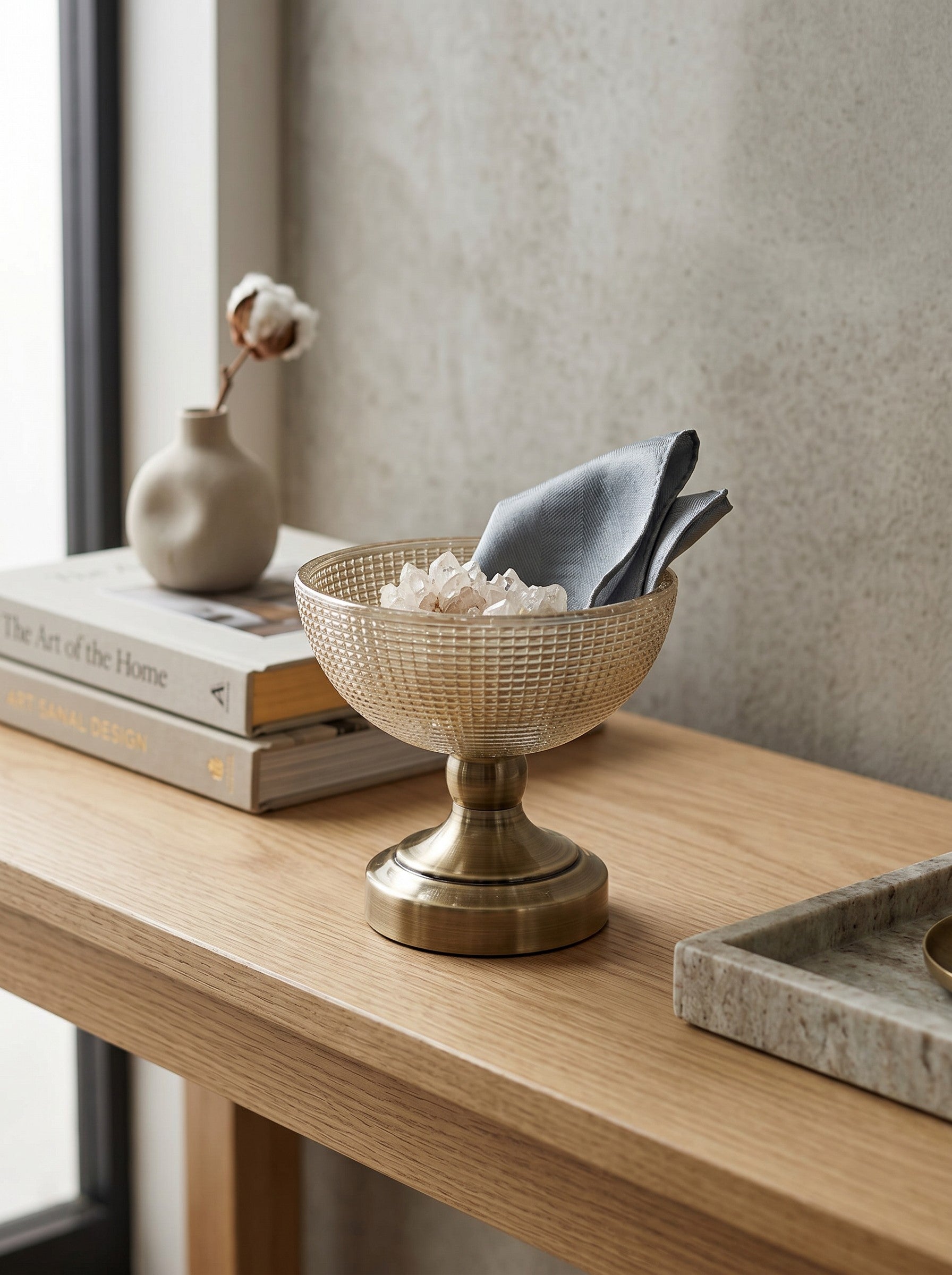 High Objects textured amber glass bowl with a brass pedestal base, perfect for decorative use.