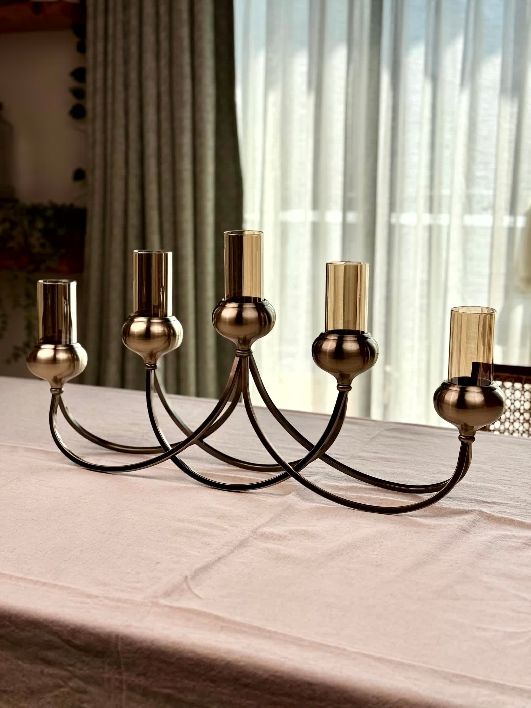 High Objects Aria Five-Arm Candle Stand in antique brass with glass holders, elegant centerpiece for dining tables.