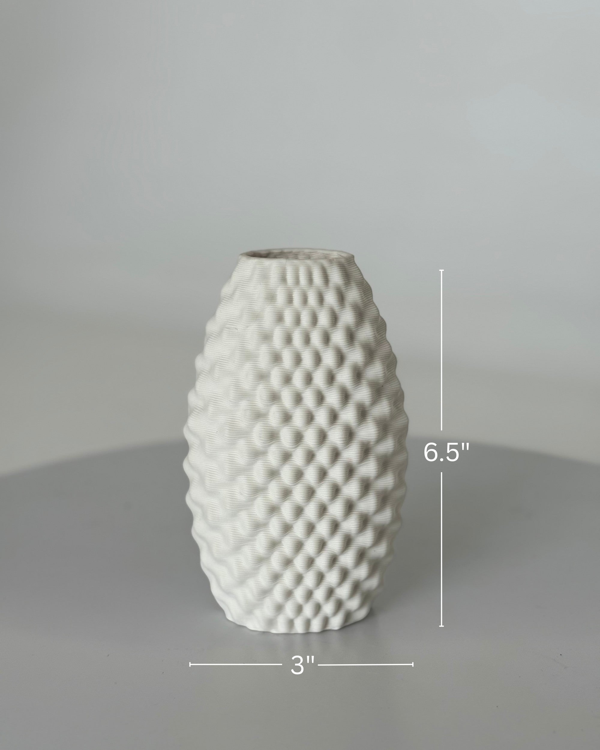 High Objects Arisca Vase, white ceramic with a textured, wave-like pattern. 6.5" H x 3" W.