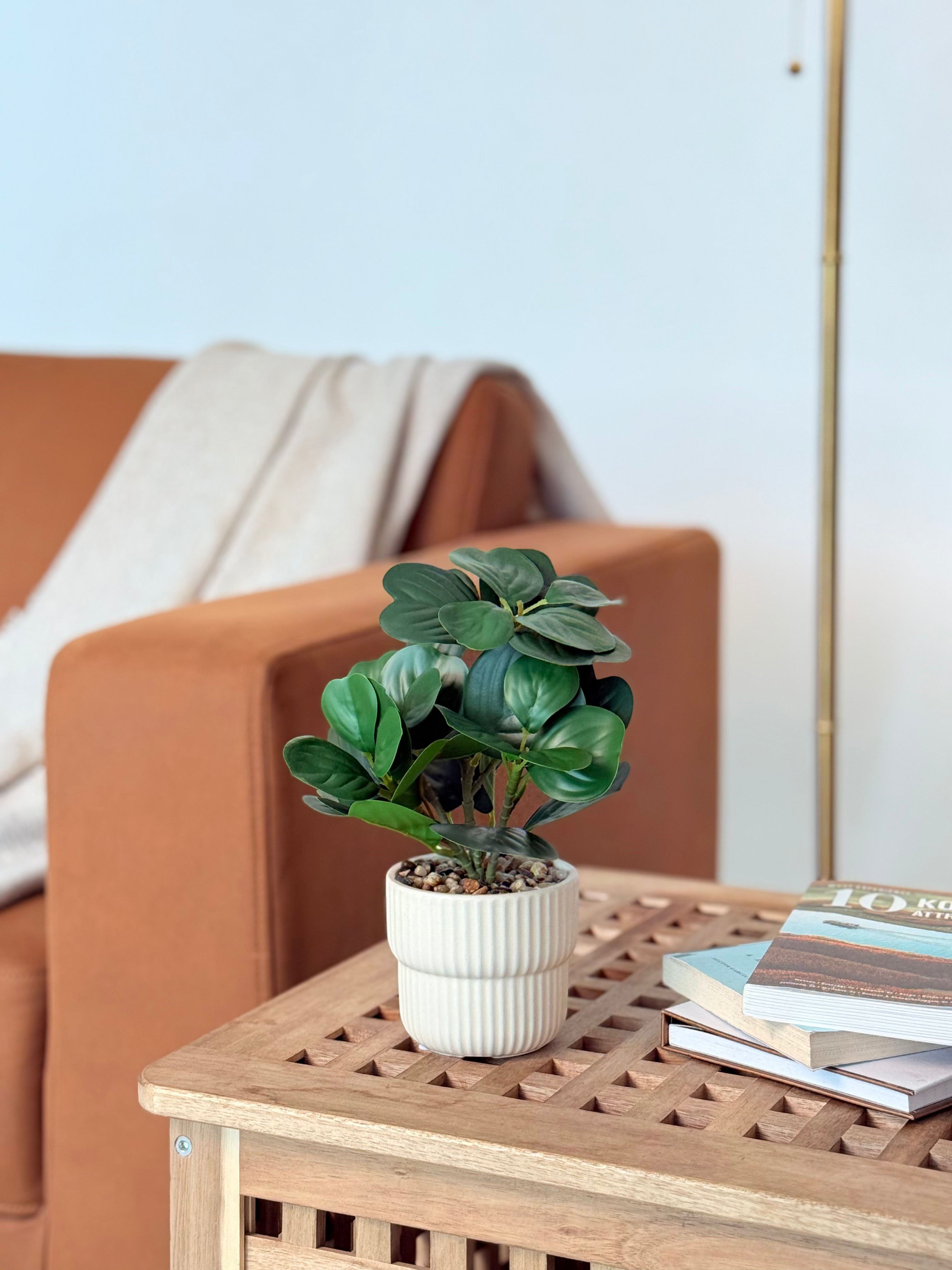 High Objects Artificial Ficus Lyrata plant in a white ribbed planter with pebble top, on a wooden table.