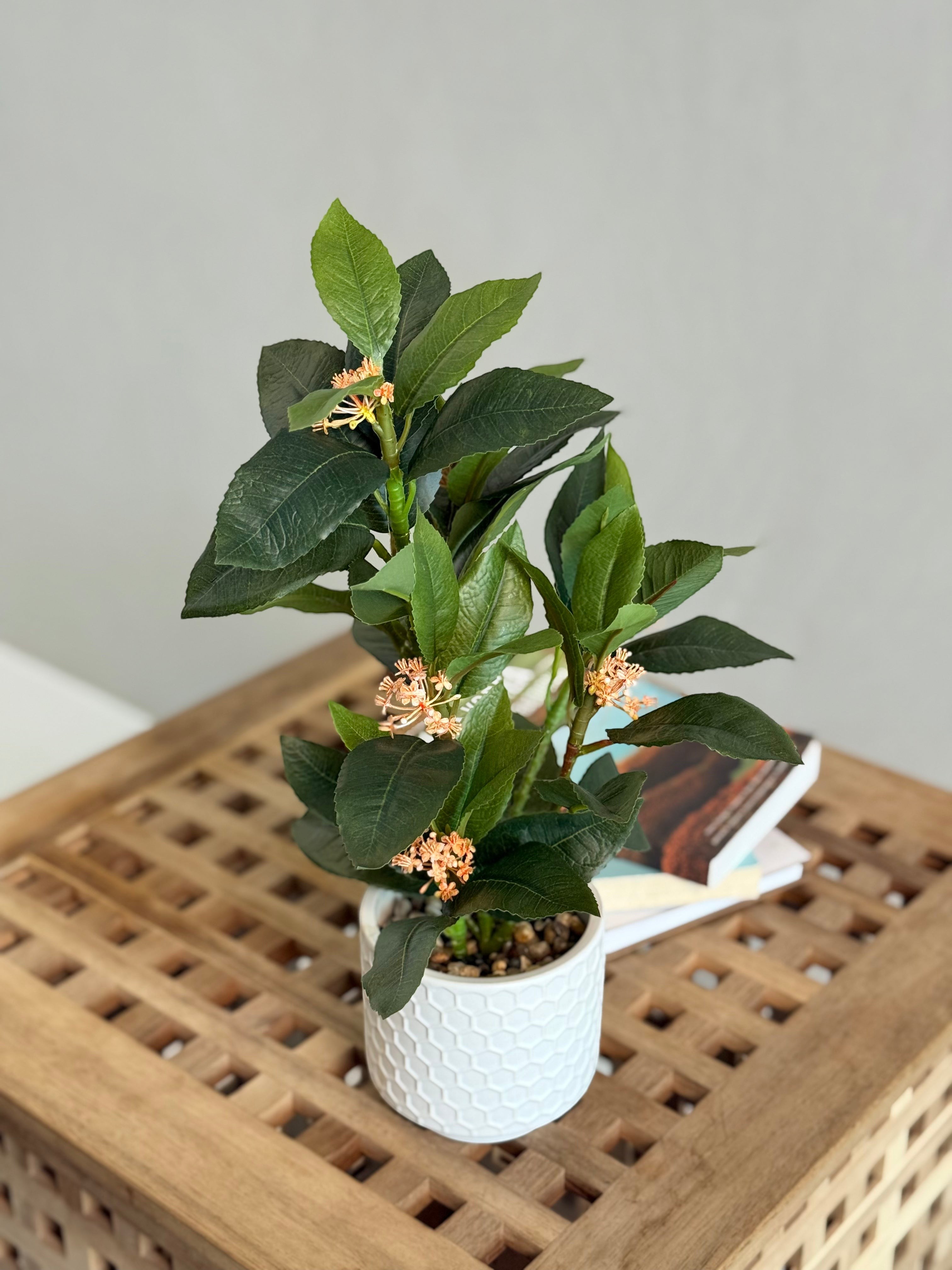 High Objects Artificial Orange Bloom Camellia Plant with green leaves in a white honeycomb pot.