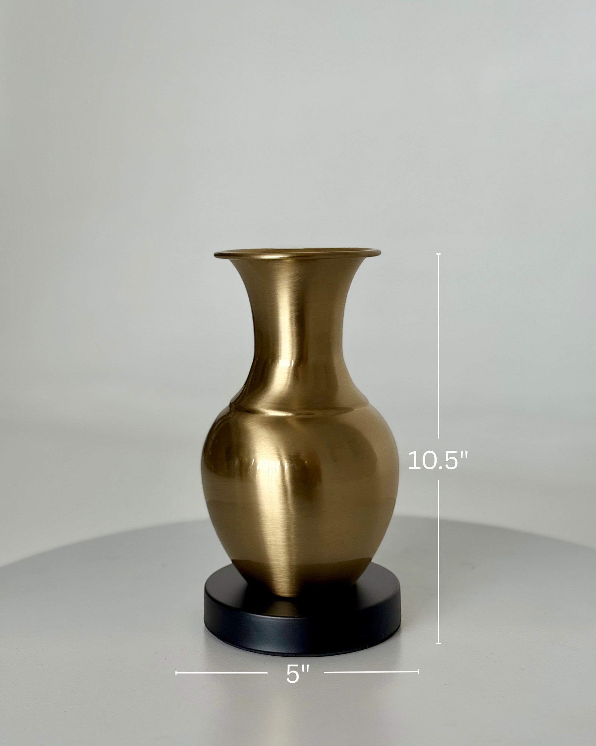 High Objects Aurelia Vase, brushed gold metallic finish, rounded body, flared neck, on a black base. 10.5" H x 5" W.