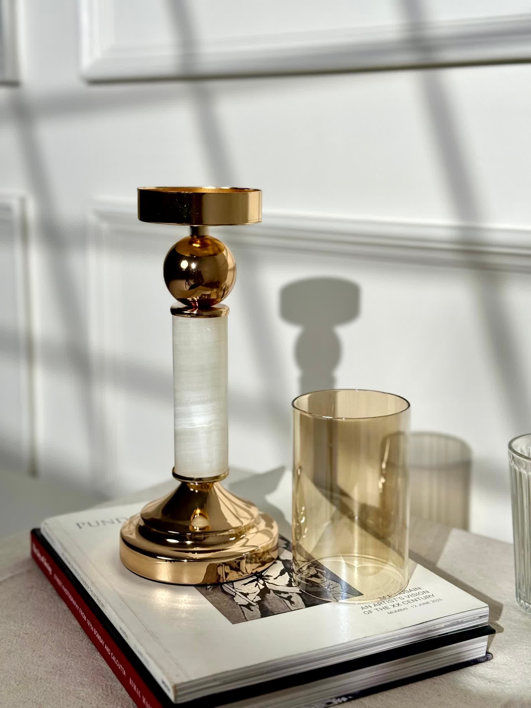 High Objects Aurora Column Candle Stand Set with polished gold accents, white marble column, and amber glass holder.