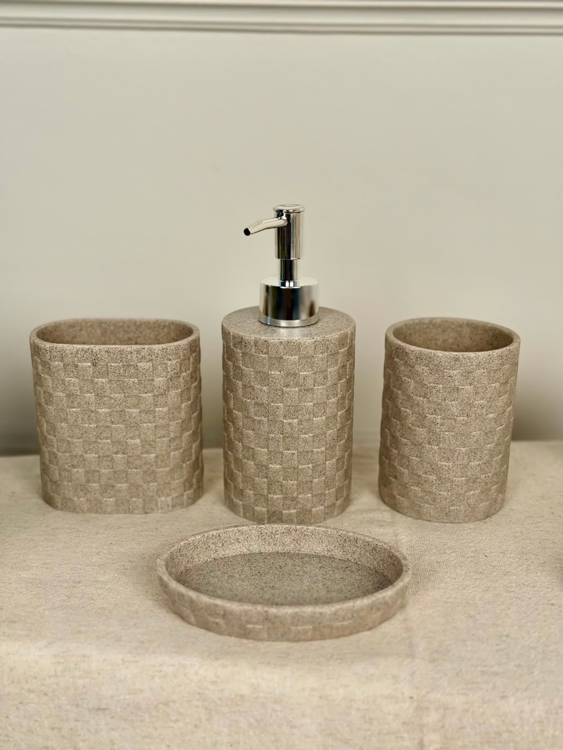 High Objects Weaveform Bathroom Accessory Set in beige with woven texture. Includes soap dispenser, toothbrush holder, cup, and soap dish.
