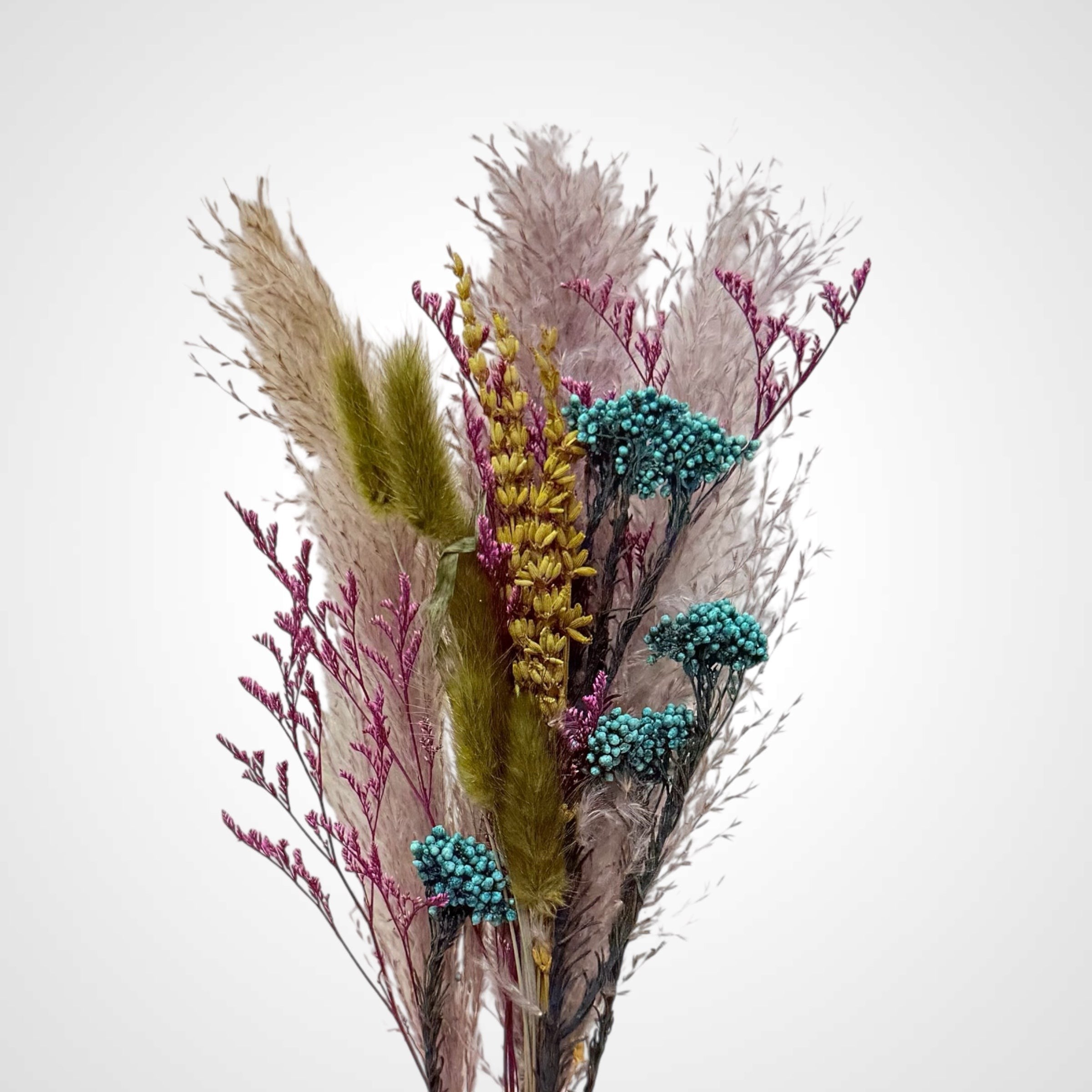 High Objects Botanical Velvet Meadow dried flower arrangement with pampas grass, bunny tails, magenta florals, and teal berries.