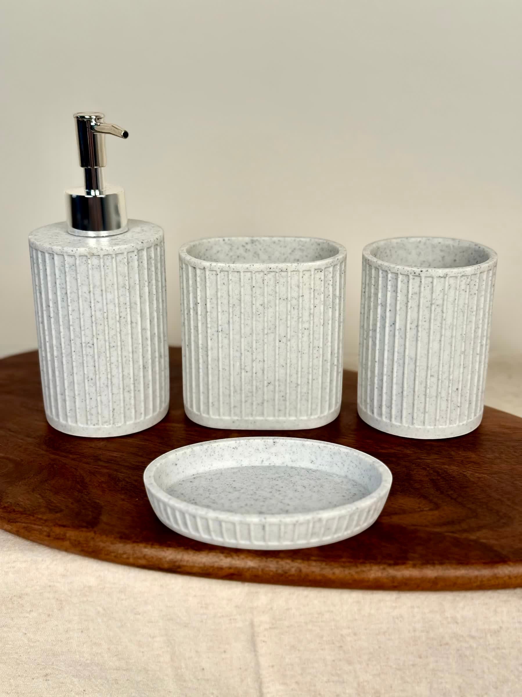 High Objects Calmridge Bathroom Accessory Set: speckled white soap dispenser, toothbrush holder, and dish with ribbed texture.
