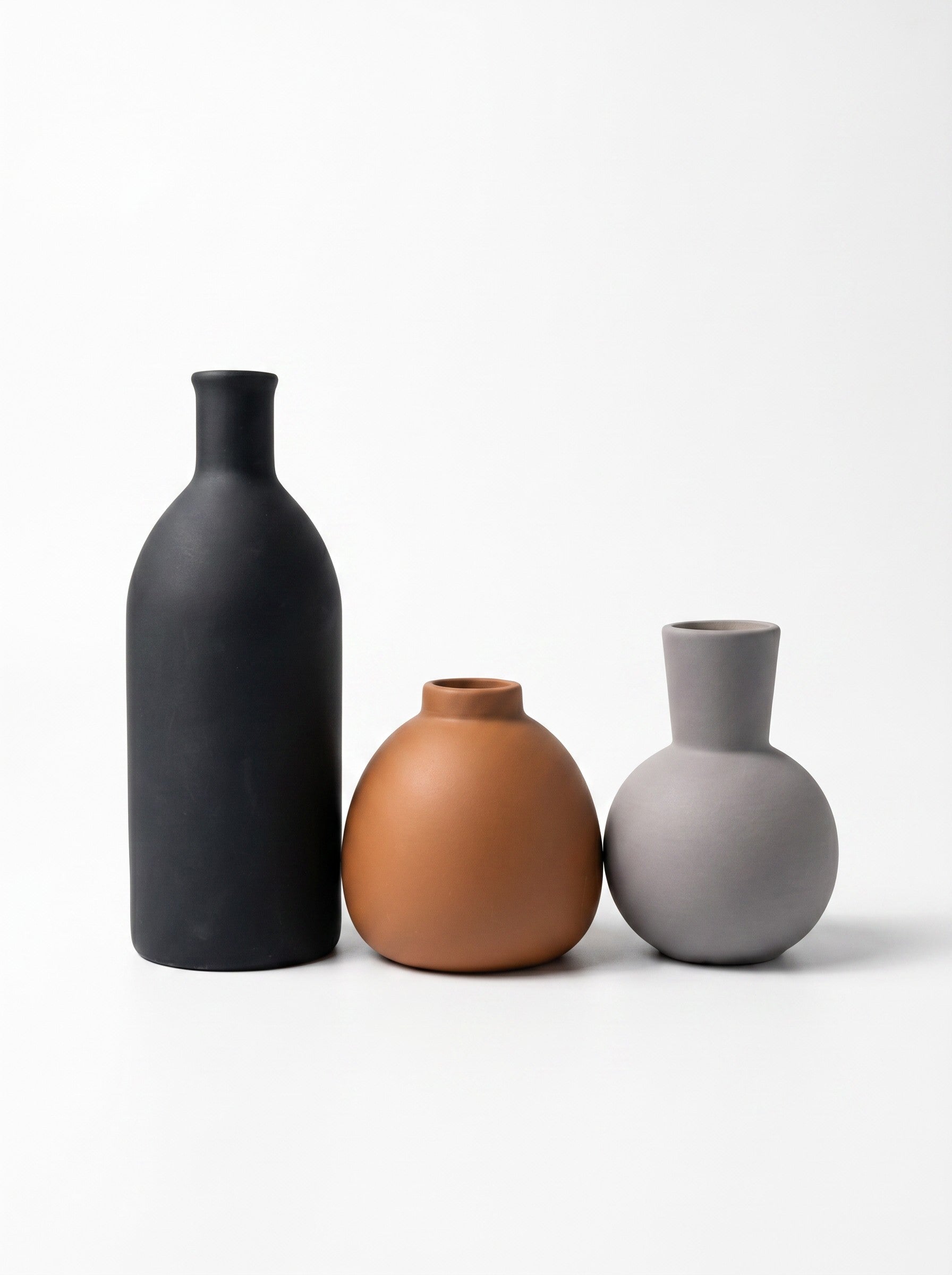 High Objects set of 3 ceramic vases in black, terracotta, and light grey, with minimalist shapes.