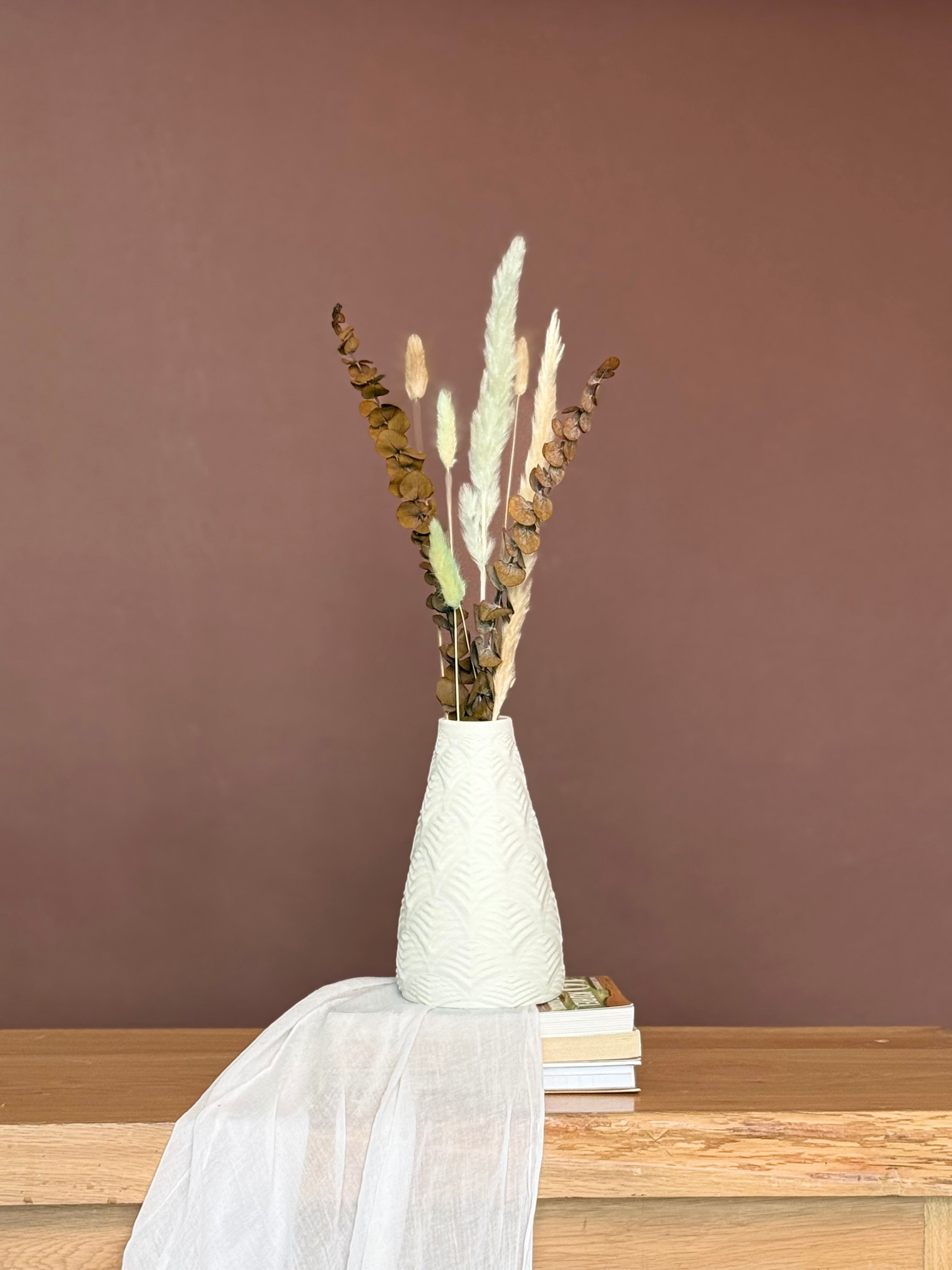 High Objects Elan Aura Vase with a stone-textured finish and sculptural silhouette, holding dried botanicals.