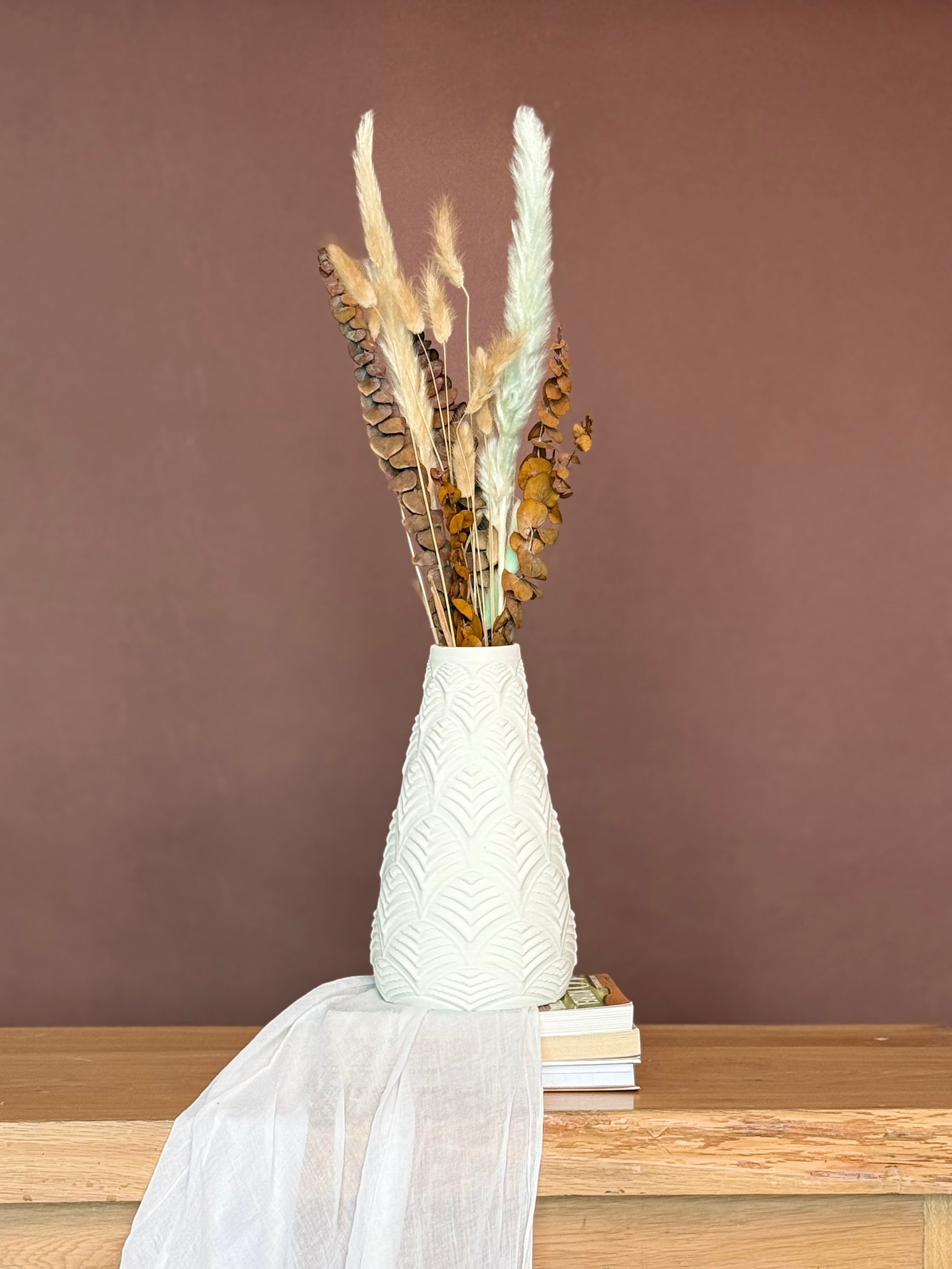 High Objects Elan Aura white textured vase with sculptural silhouette, holding dried botanicals.