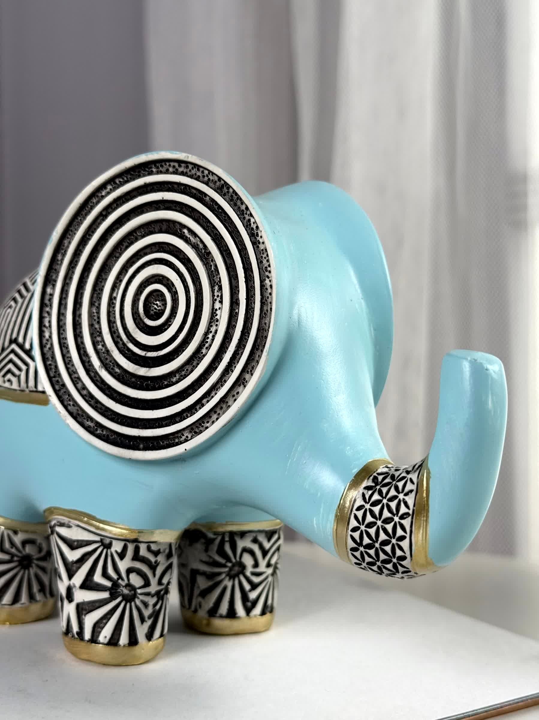 High Objects small blue polyresin elephant figurine with black and gold geometric patterns and concentric circles on ears.