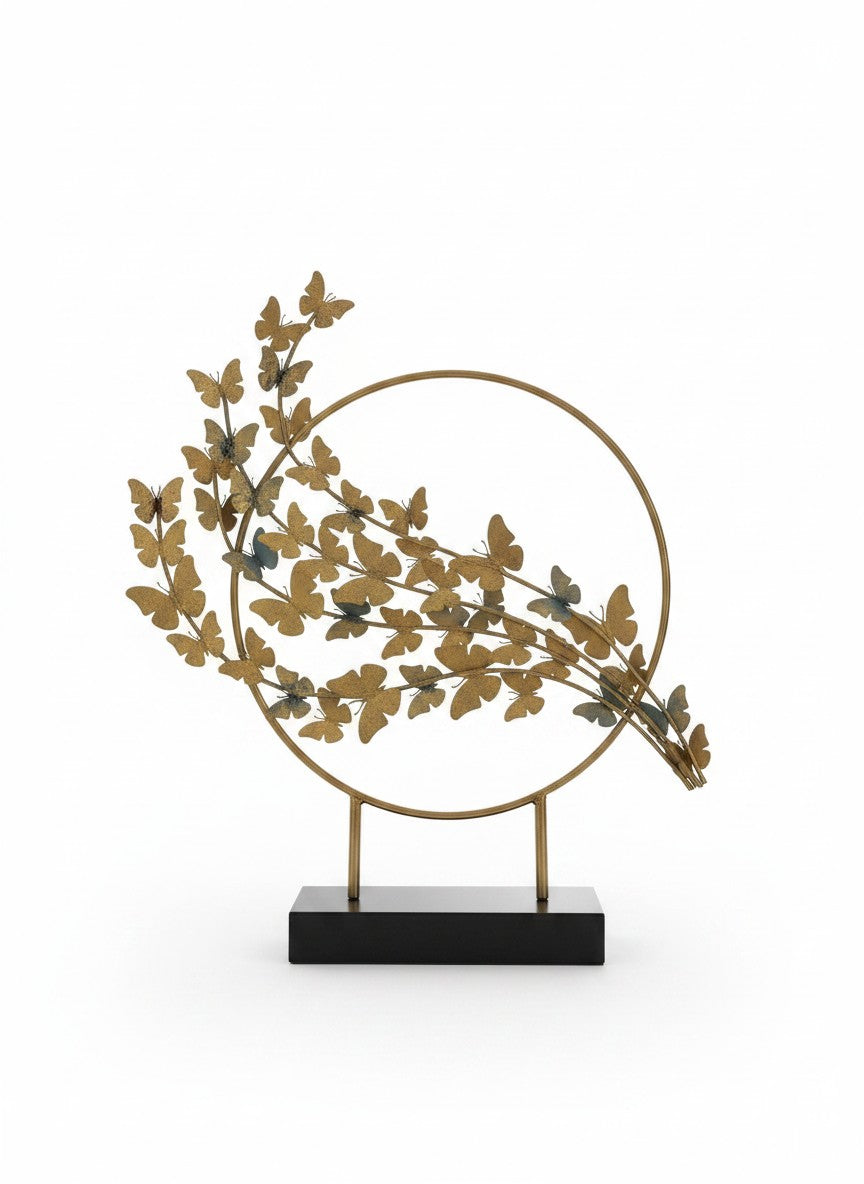 High Objects gold metal butterfly branch sculpture with circular frame and black base.