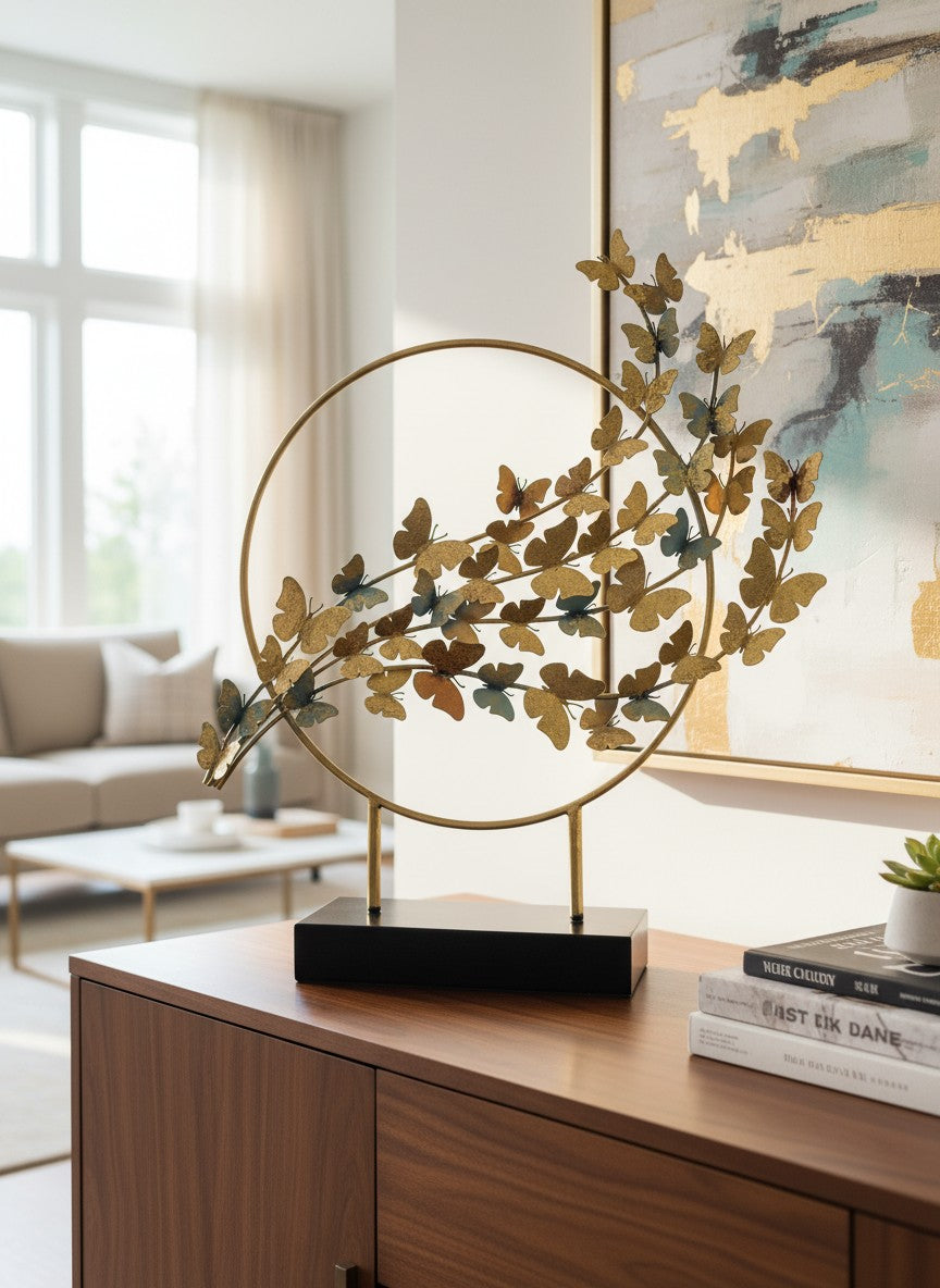 High Objects gold metal showpiece with a circular frame and a cluster of butterflies in varying sizes and shades of gold and blue.