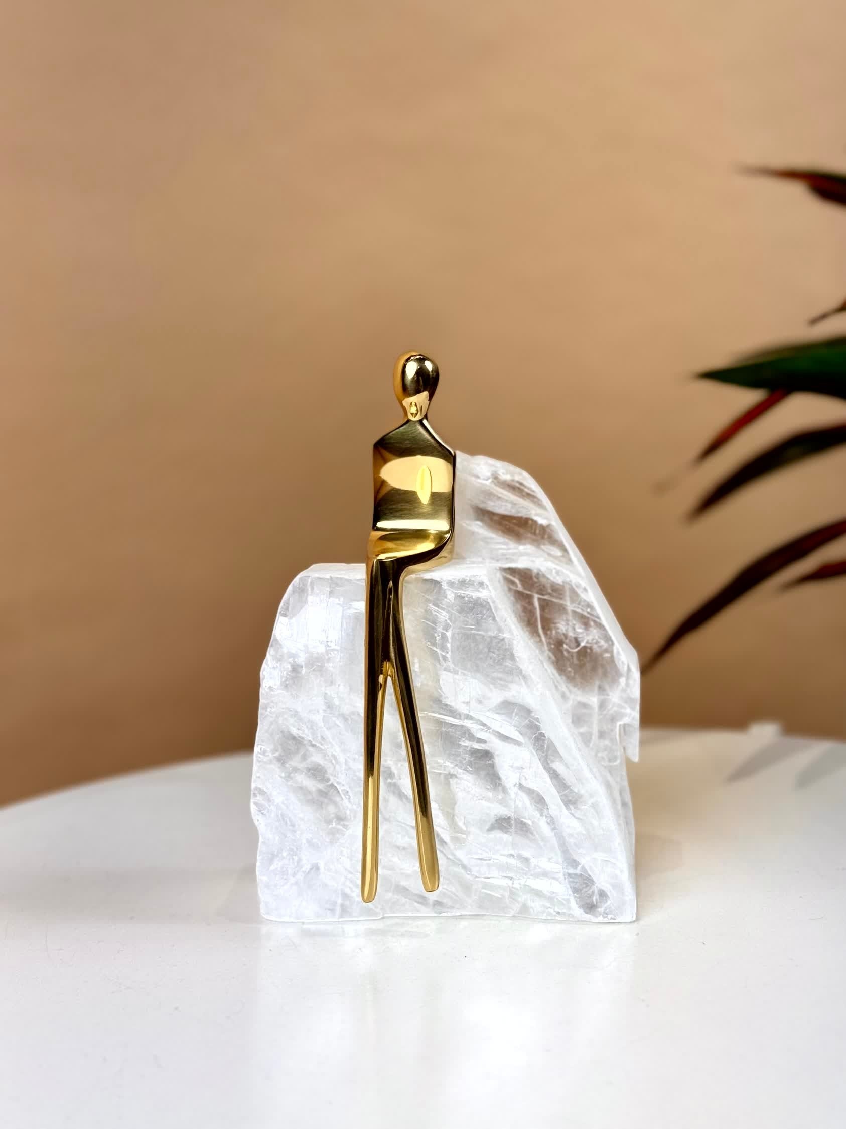 High Objects Golden Poise abstract sculpture of a figure in polished gold-finished iron on a natural crystal base.
