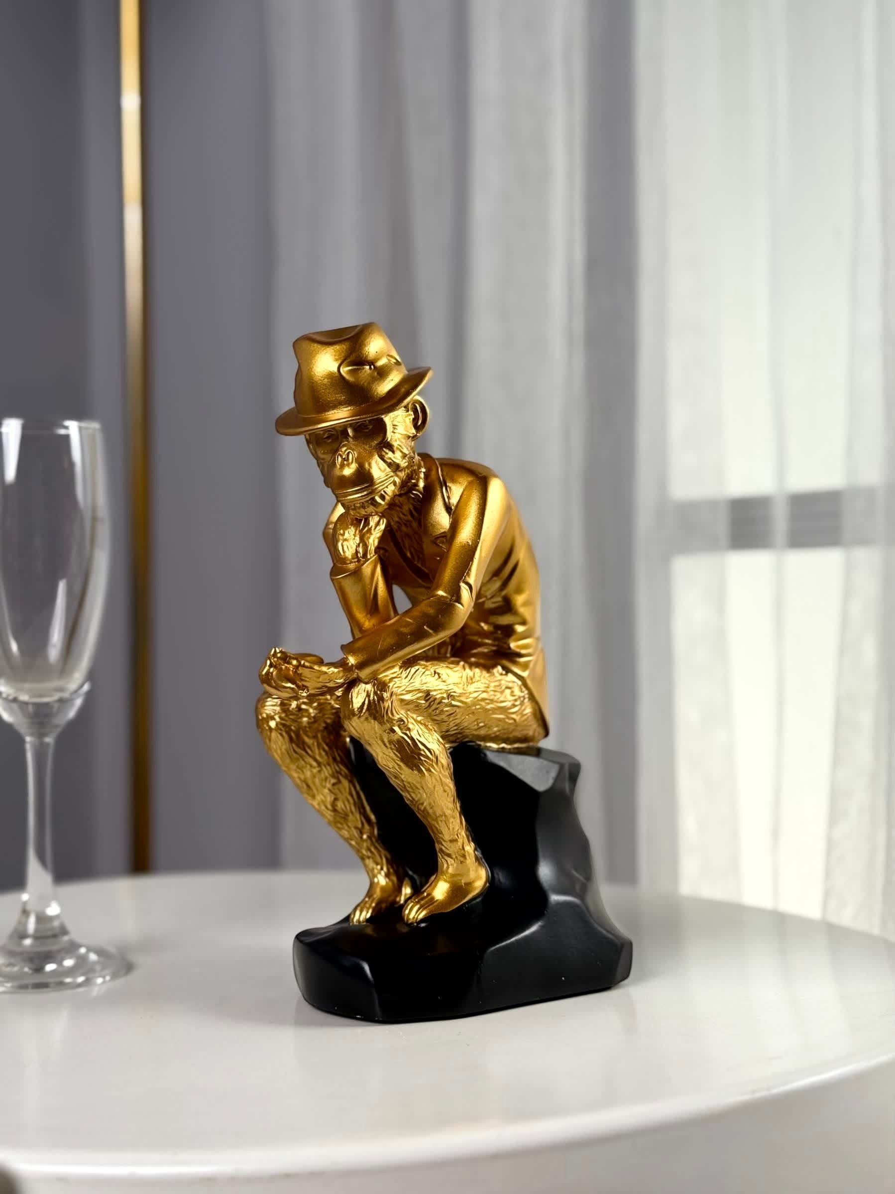 High Objects Golden Thinker showpiece, a monkey in a fedora and gold suit sitting thoughtfully on a black base.