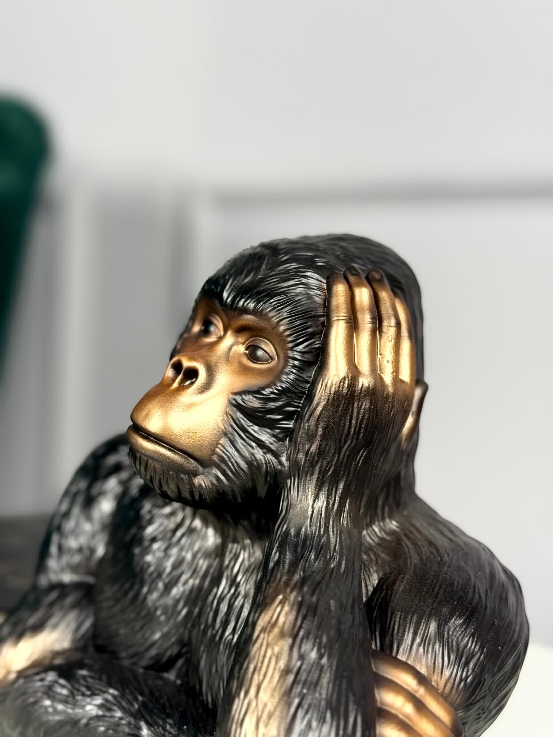 High Objects Pensive Gorilla showpiece sculpture with a golden face and dark textured body, resting head on hand.
