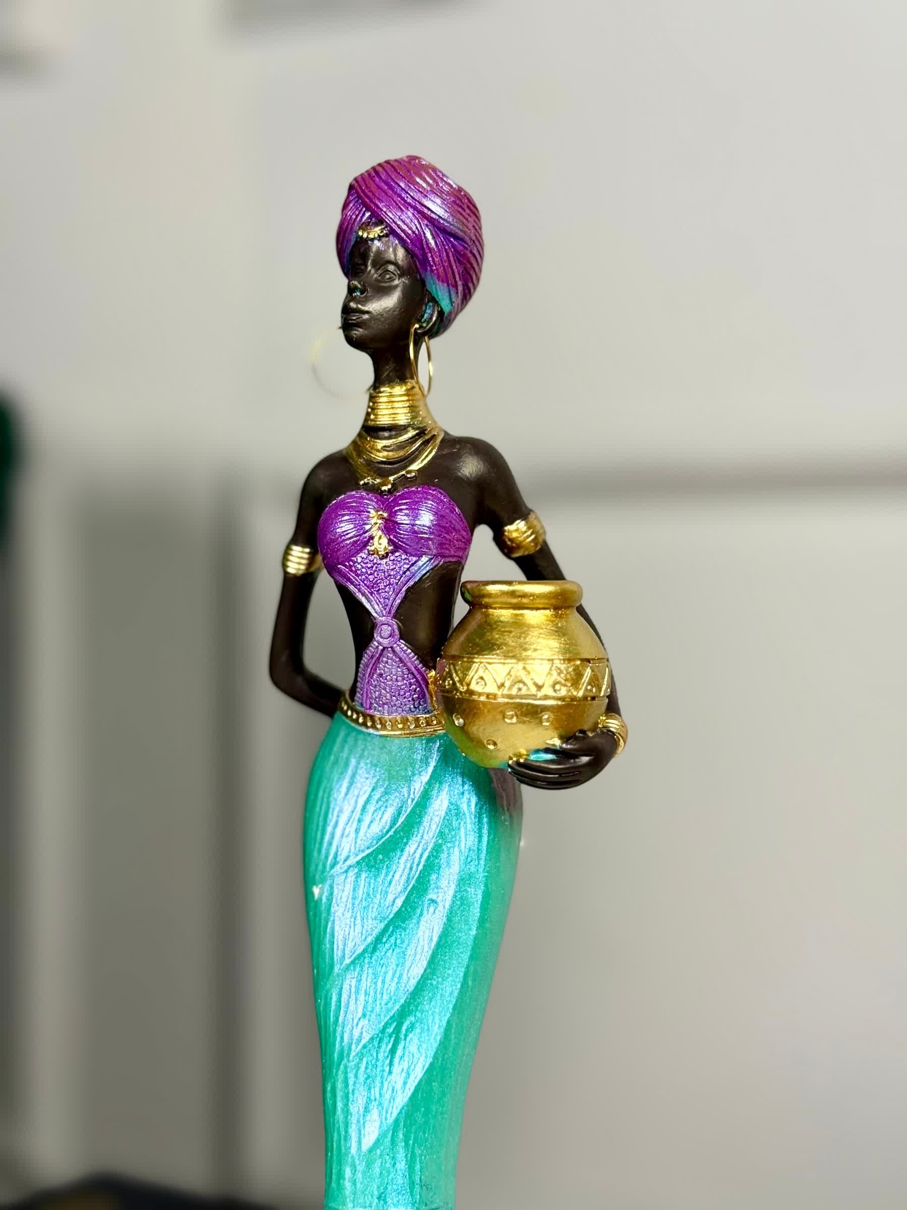 High Objects Grace of the Nile showpiece: African woman sculpture, 12-inch, polyresin, holding gold pot. Purple, turquoise attire.