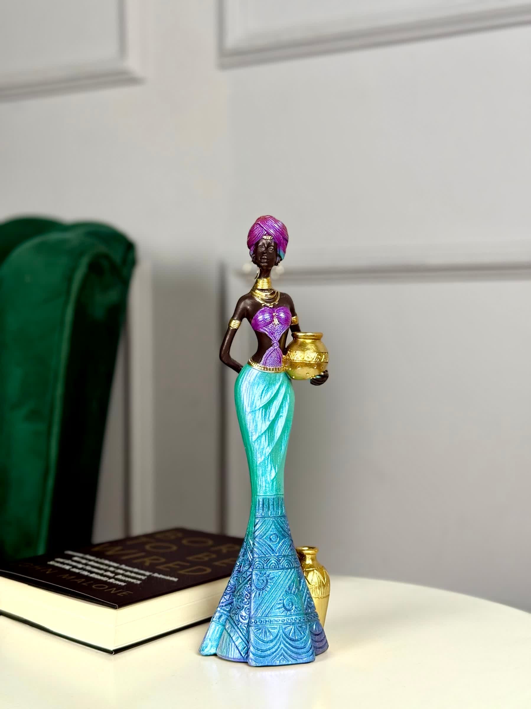 High Objects Grace of the Nile showpiece: African woman sculpture, 12-inch polyresin, holding gold pot. Purple, turquoise, blue attire.