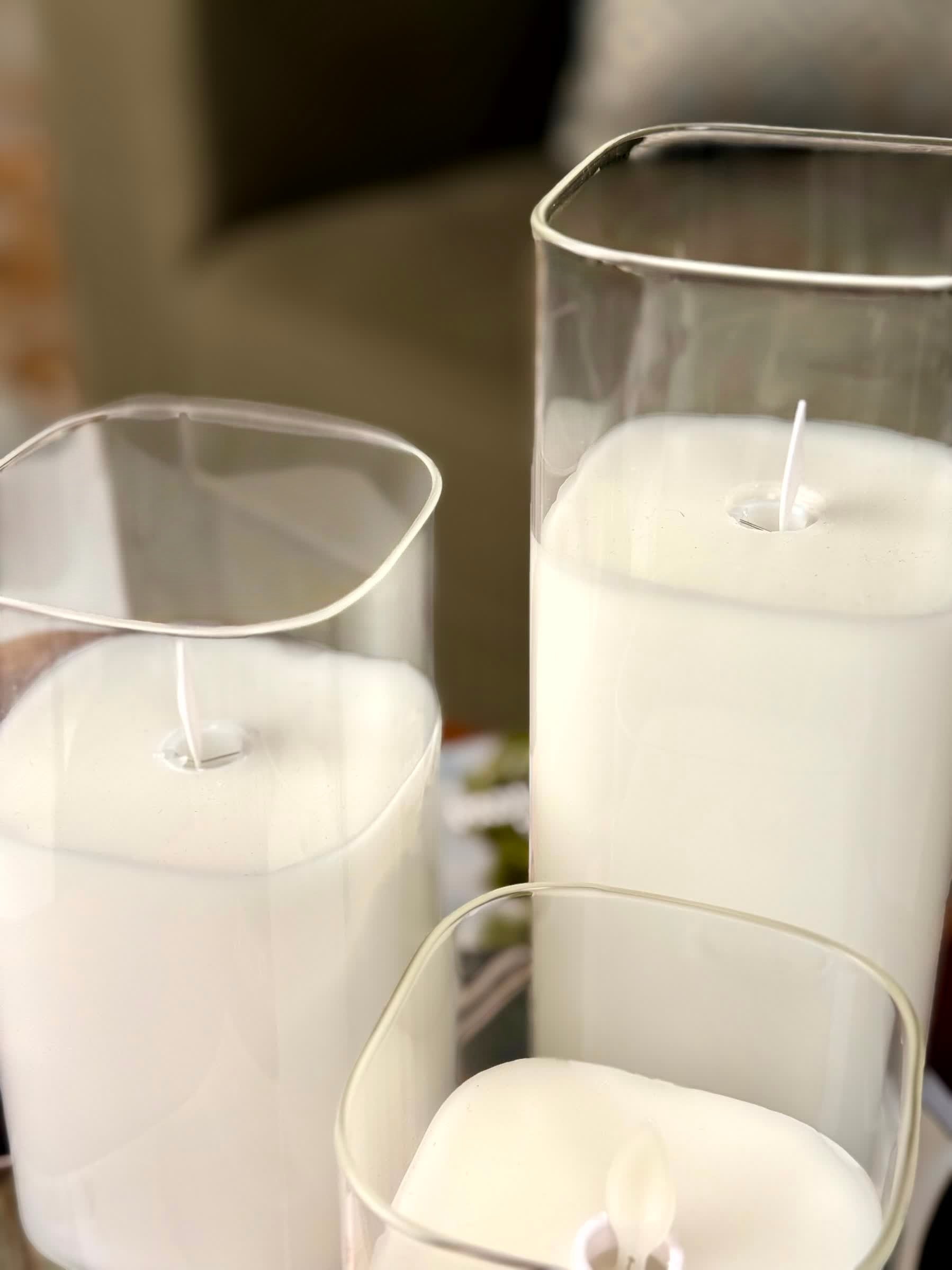 High Objects Halomist LED candles in white wax with clear glass cylinders, featuring modern rounded square and cylindrical shapes.