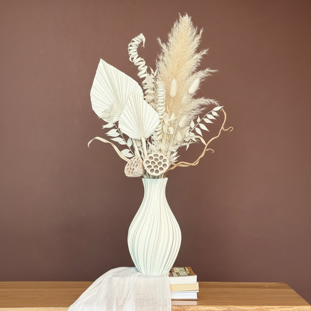 High Objects Lunara Vase, a white ceramic vase with a ribbed pattern, holding dried flowers.
