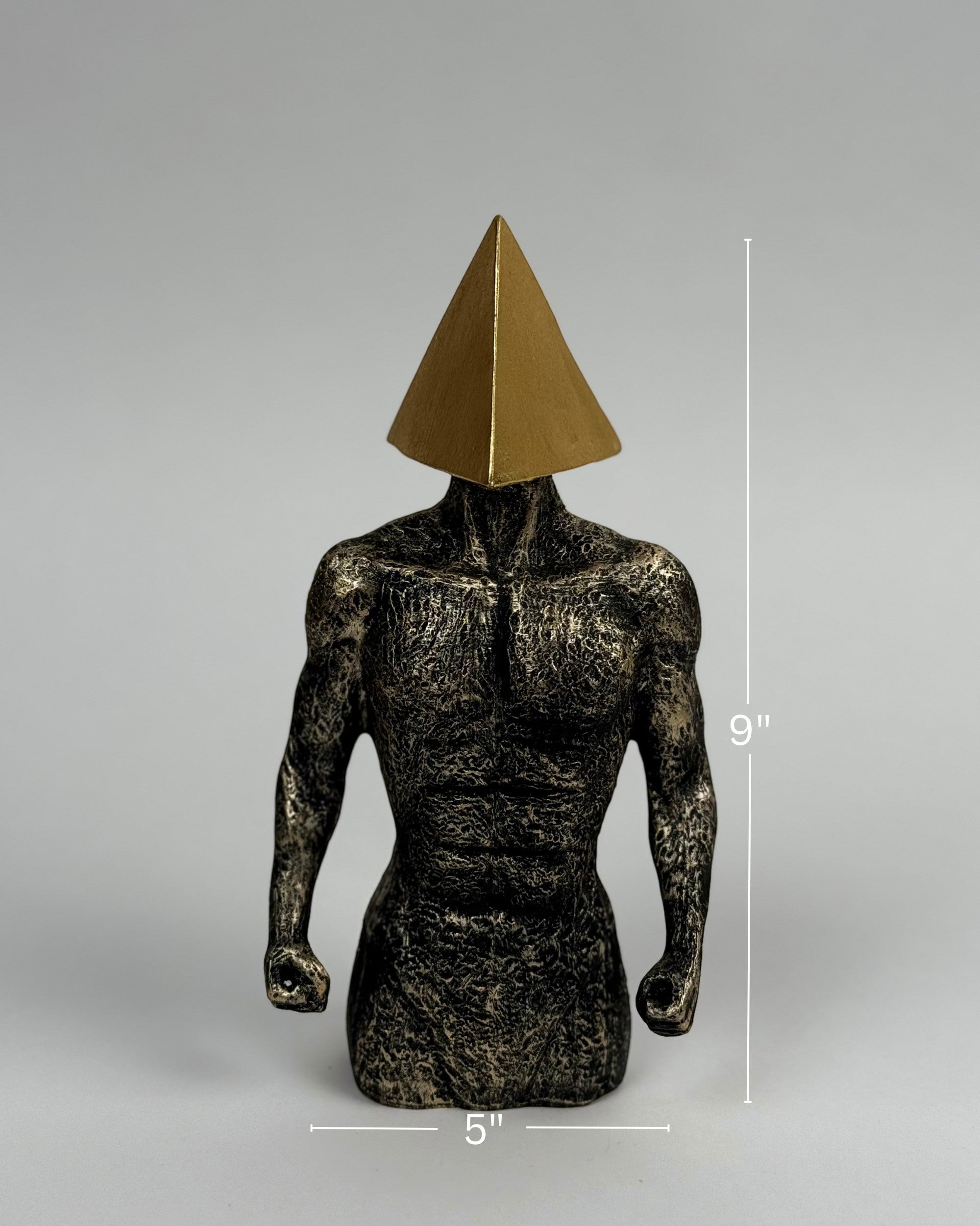 High Objects abstract sculpture of a muscular torso with a gold pyramid head, textured stone finish, 9" tall.