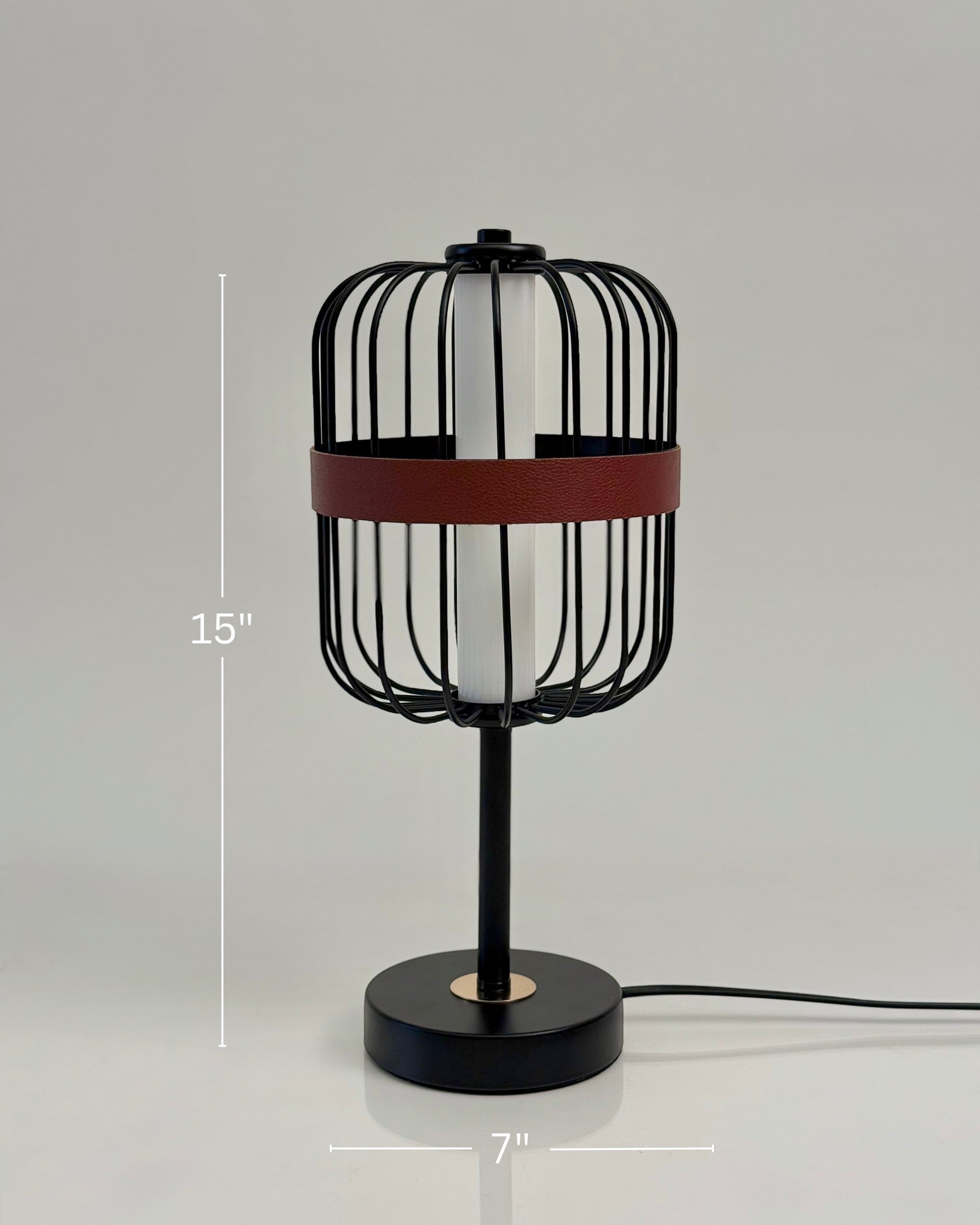 High Objects Noir Ember Cage Table Lamp with matte black wire cage, red leather accent, and gold base detail.