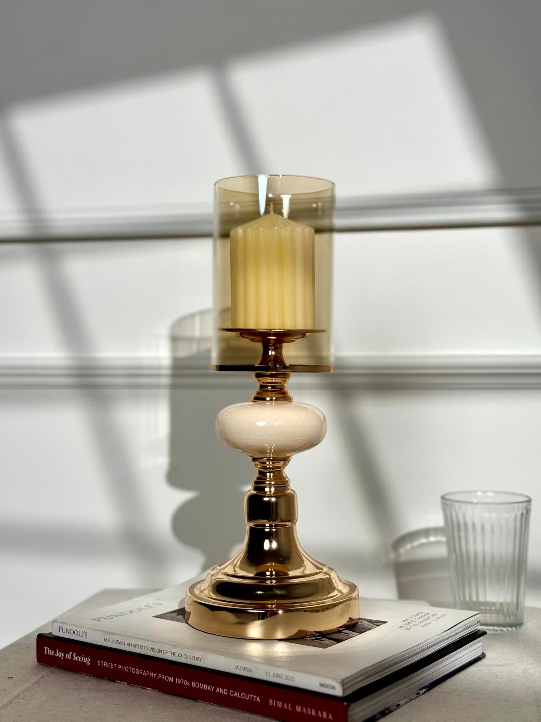 High Objects Opaline Gold Candle Stand Collection with amber glass hurricane shade and opaline accents.