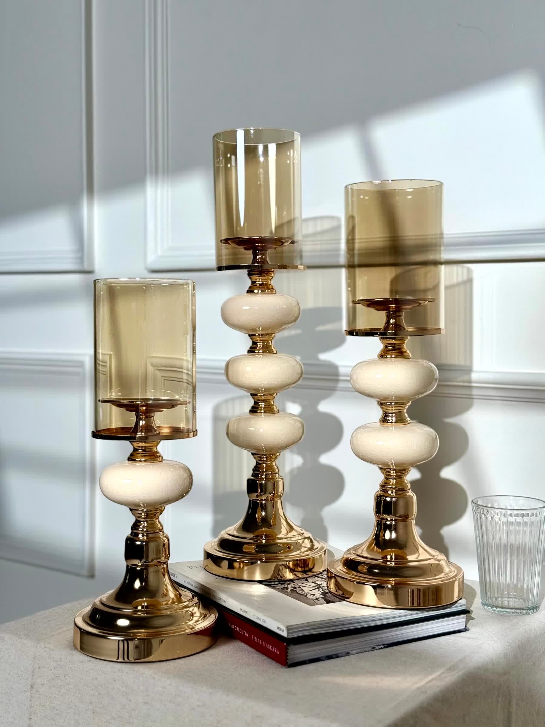 High Objects Opaline Gold Candle Stand Collection set of 3, featuring gold bases, opaline accents, and amber glass shades.