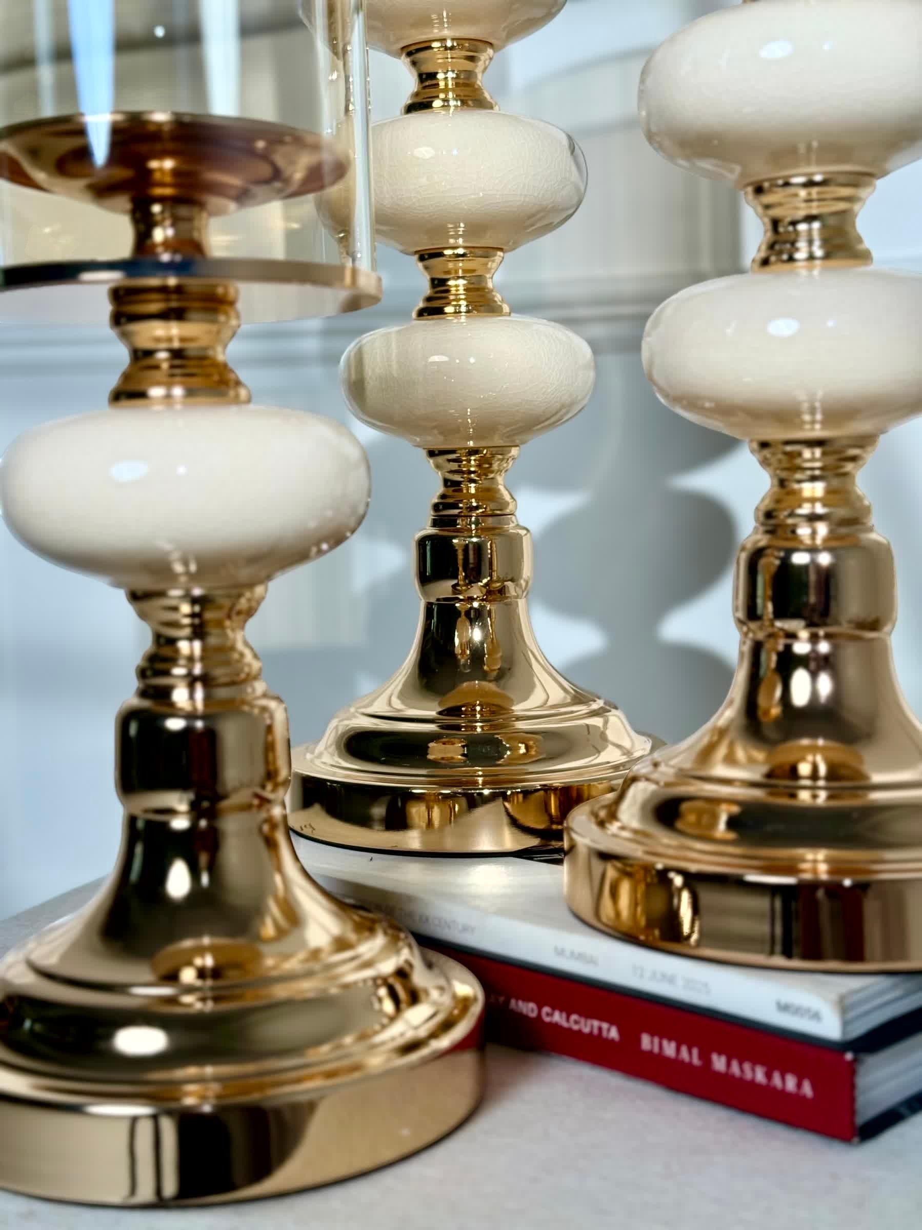 High Objects Opaline Gold Candle Stand Collection: Set of 3 gold candle holders with opaline accents and amber glass shades.