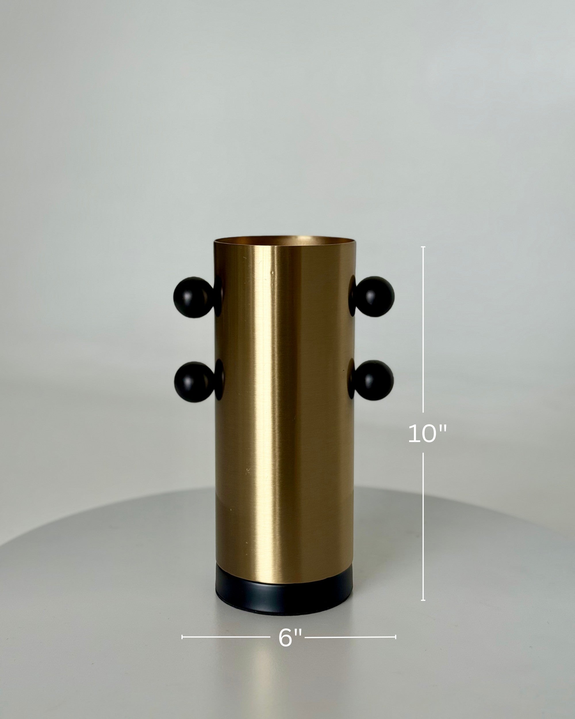 High Objects Orbis Luxe cylindrical gold vase with black orb accents, 10" H x 6" W.