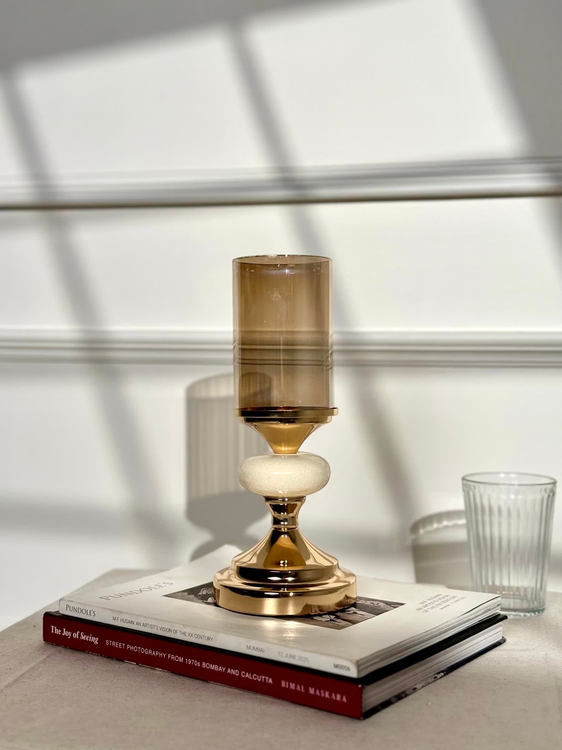 High Objects Pebble Luxe Candle Stand Set, gold metal with amber glass hurricane and textured stone accent.
