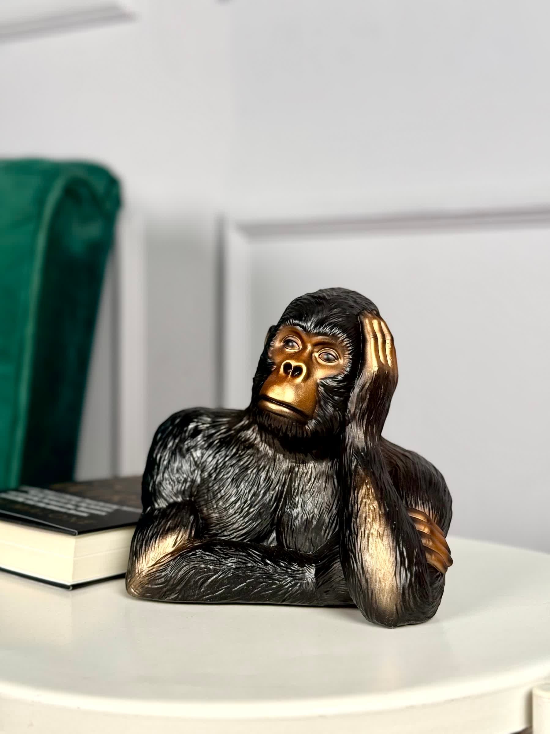 High Objects Pensive Gorilla showpiece sculpture with a golden face and black textured body, resting head on hand.