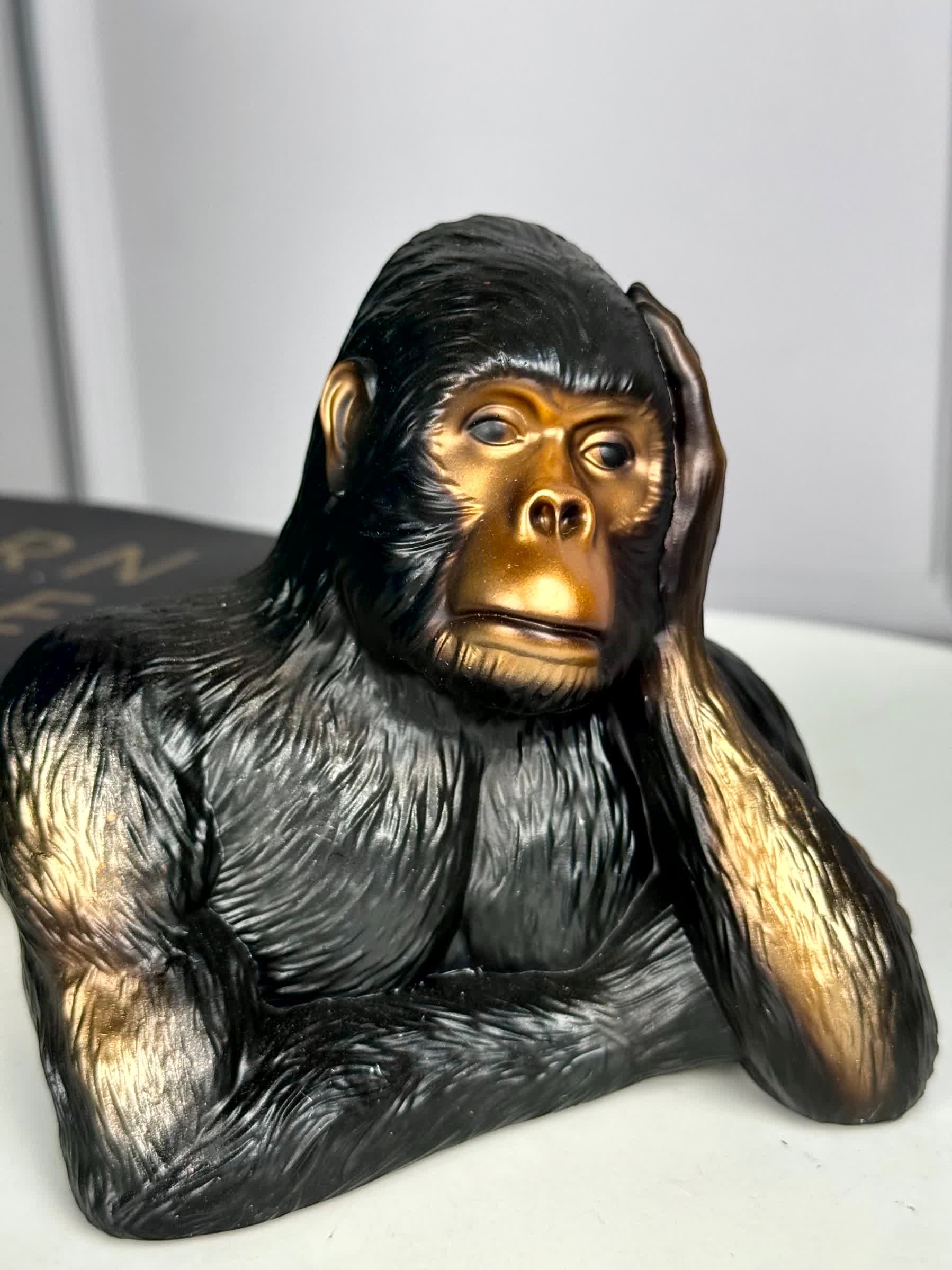 High Objects Pensive Gorilla showpiece sculpture with black textured body and gold face, resting head on hand.