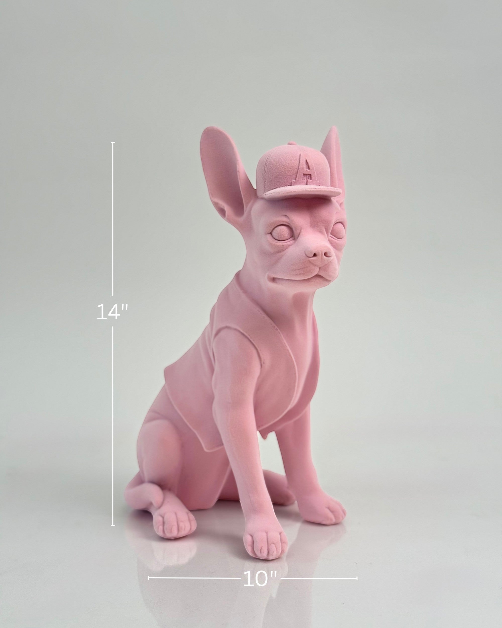 High Objects matte pink French bulldog sculpture wearing a baseball cap and vest.