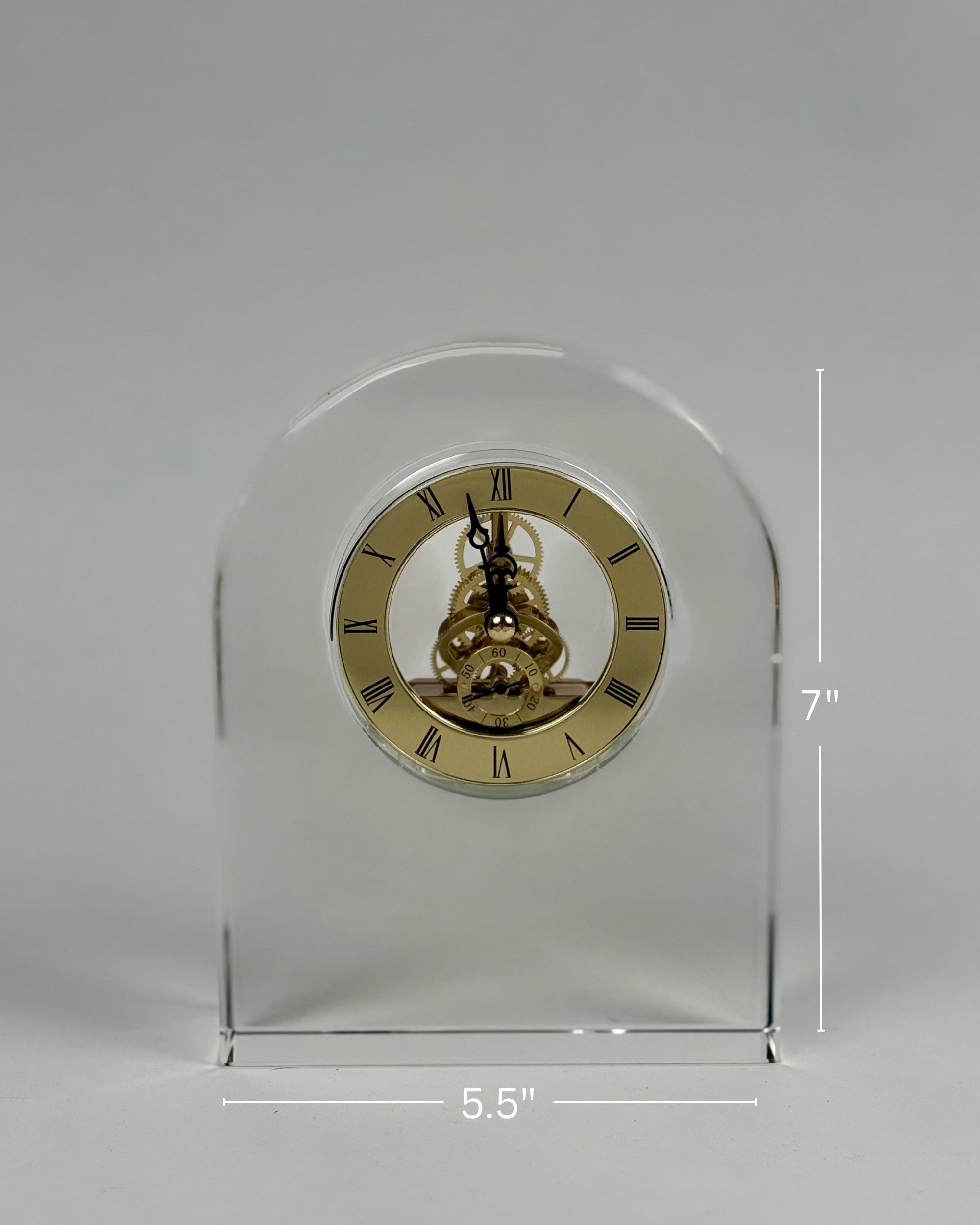 High Objects Regal Crystal Desk Clock with exposed gears and gold Roman numerals. Arched silhouette, clear polished crystal.