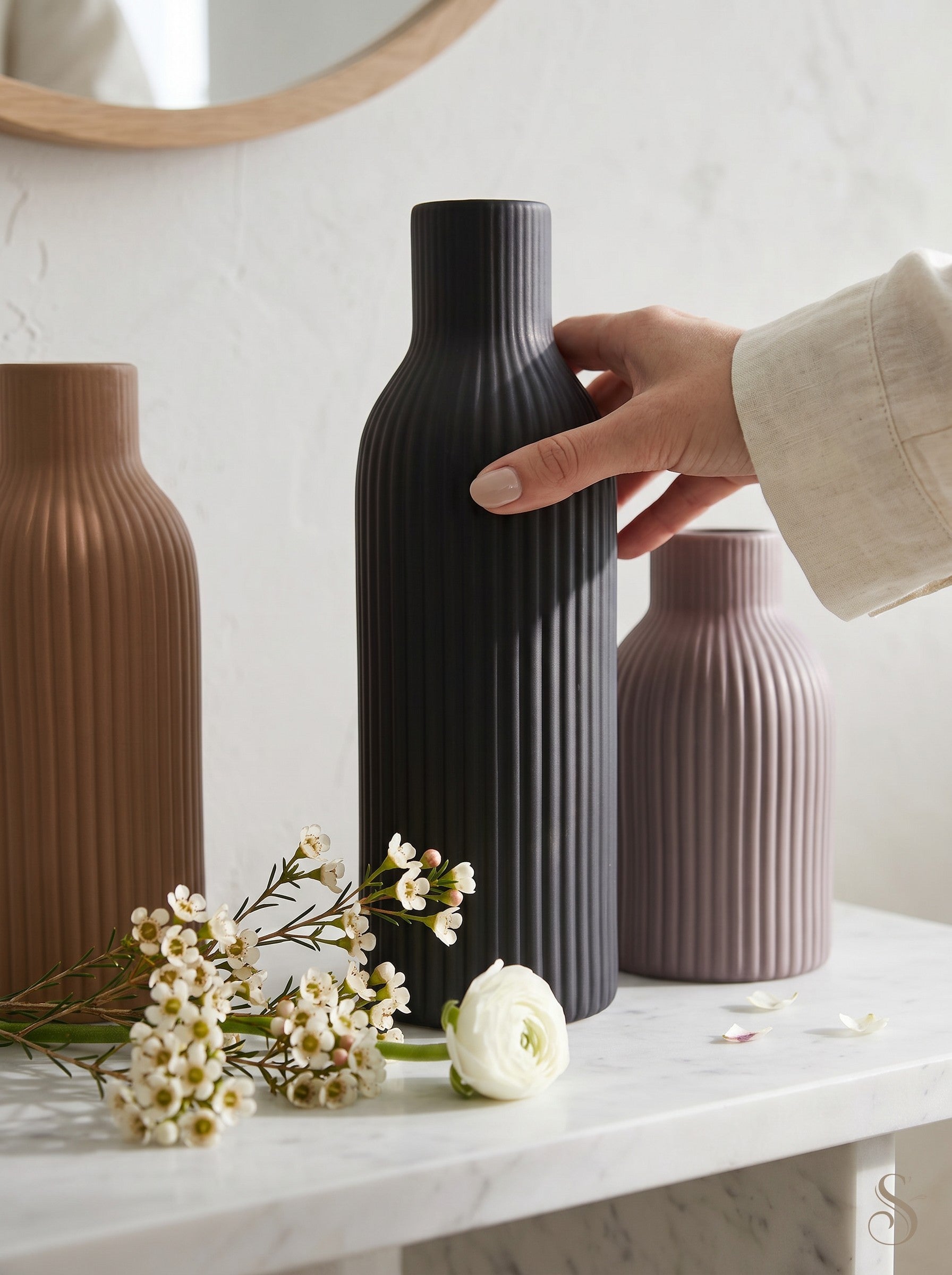 High Objects ribbed ceramic vases in brown, black, and mauve, styled with dried pampas grass and white flowers.
