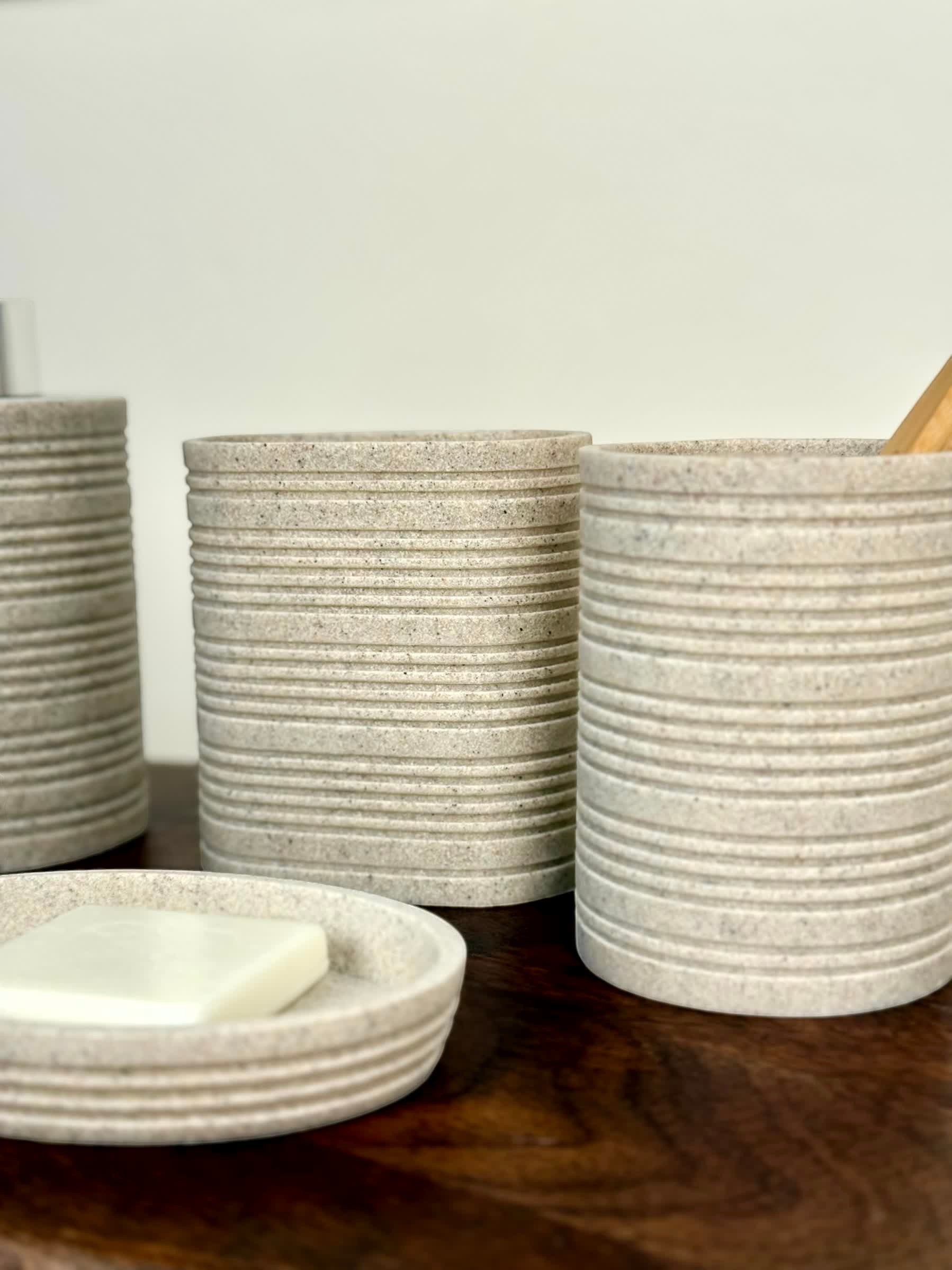 High Objects Ridgeline Bathroom Accessory Set in speckled stone with horizontal ridges. Includes soap dish and tumblers.