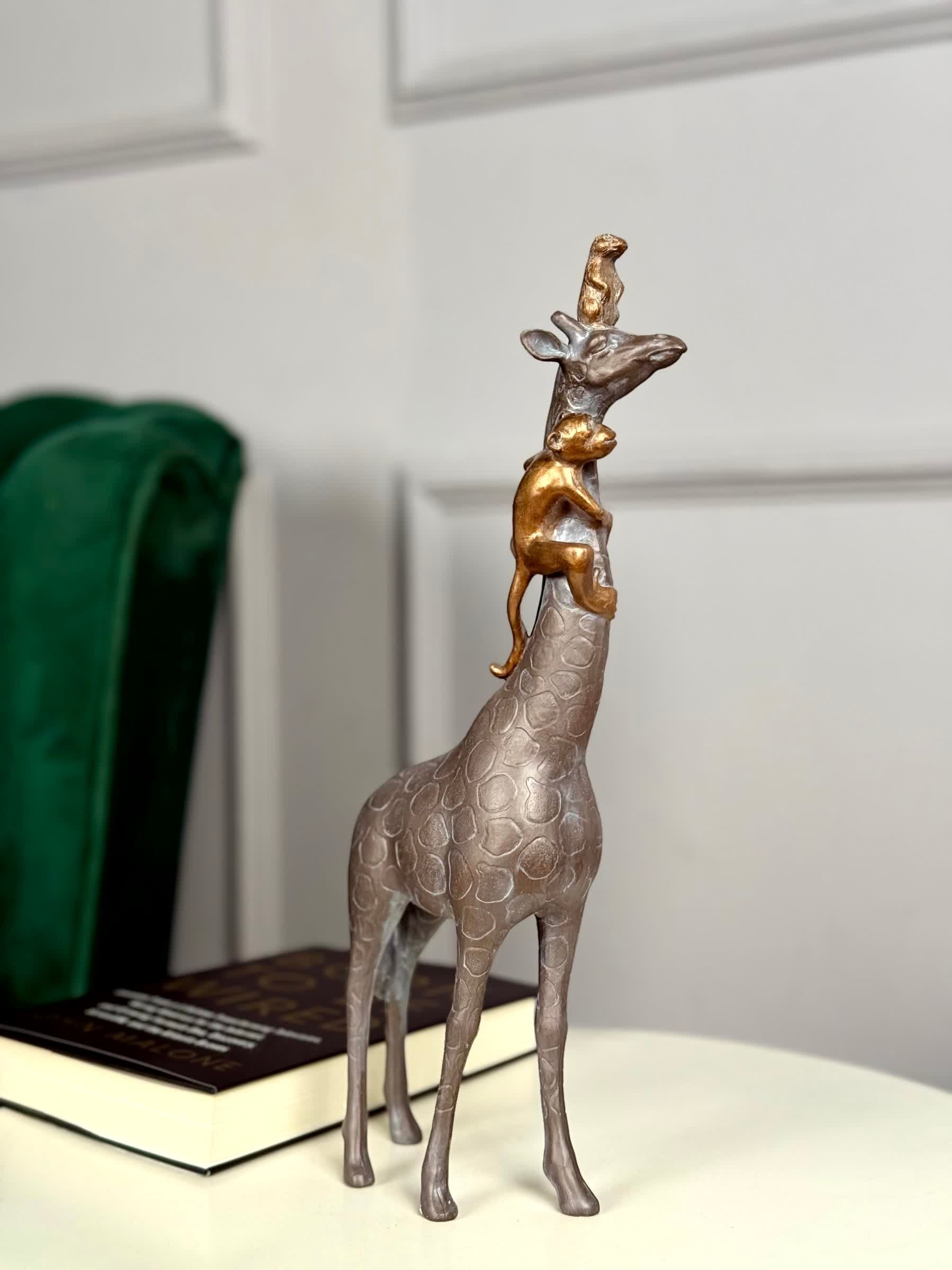 High Objects Savannah Majesty Showpiece sculpture of a giraffe with two monkeys climbing its neck, made of polyresin with a dark finish.