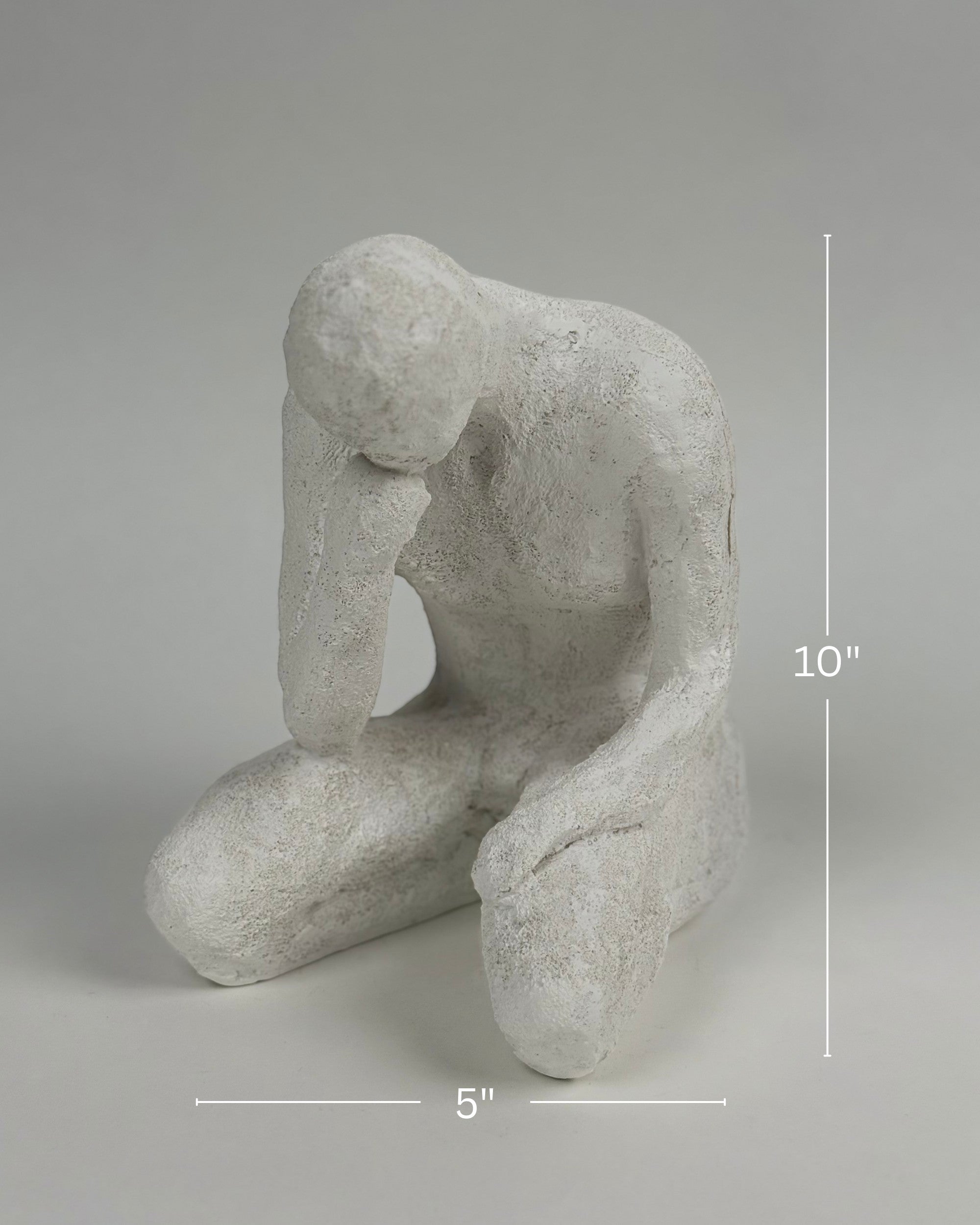 High Objects textured white polyresin showpiece of a faceless figure in a contemplative pose, 10" tall.