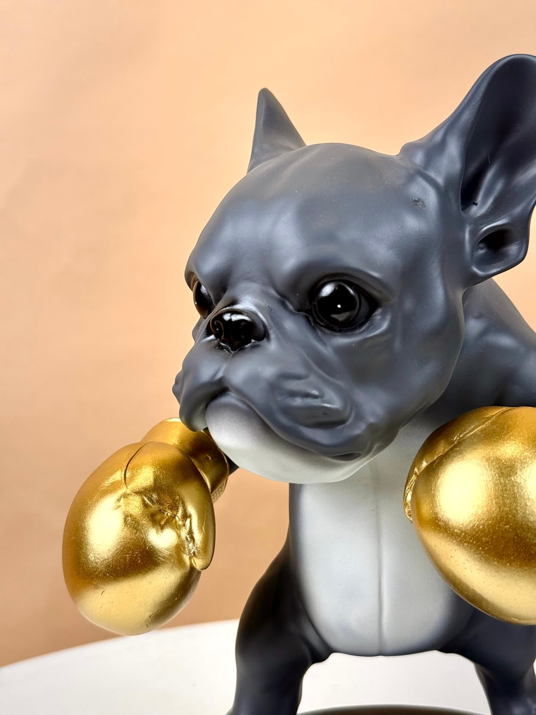 High Objects Sport Bulldog showpiece in matte black, grey, and gold boxing gloves.