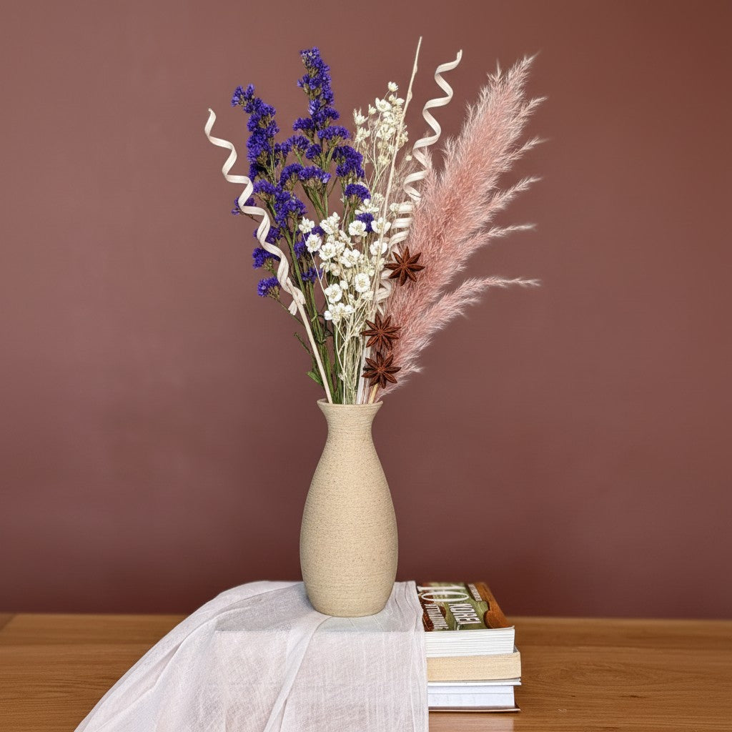 High Objects TerraLume ceramic vase in beige with organic curves, holding dried bunny tail grass.