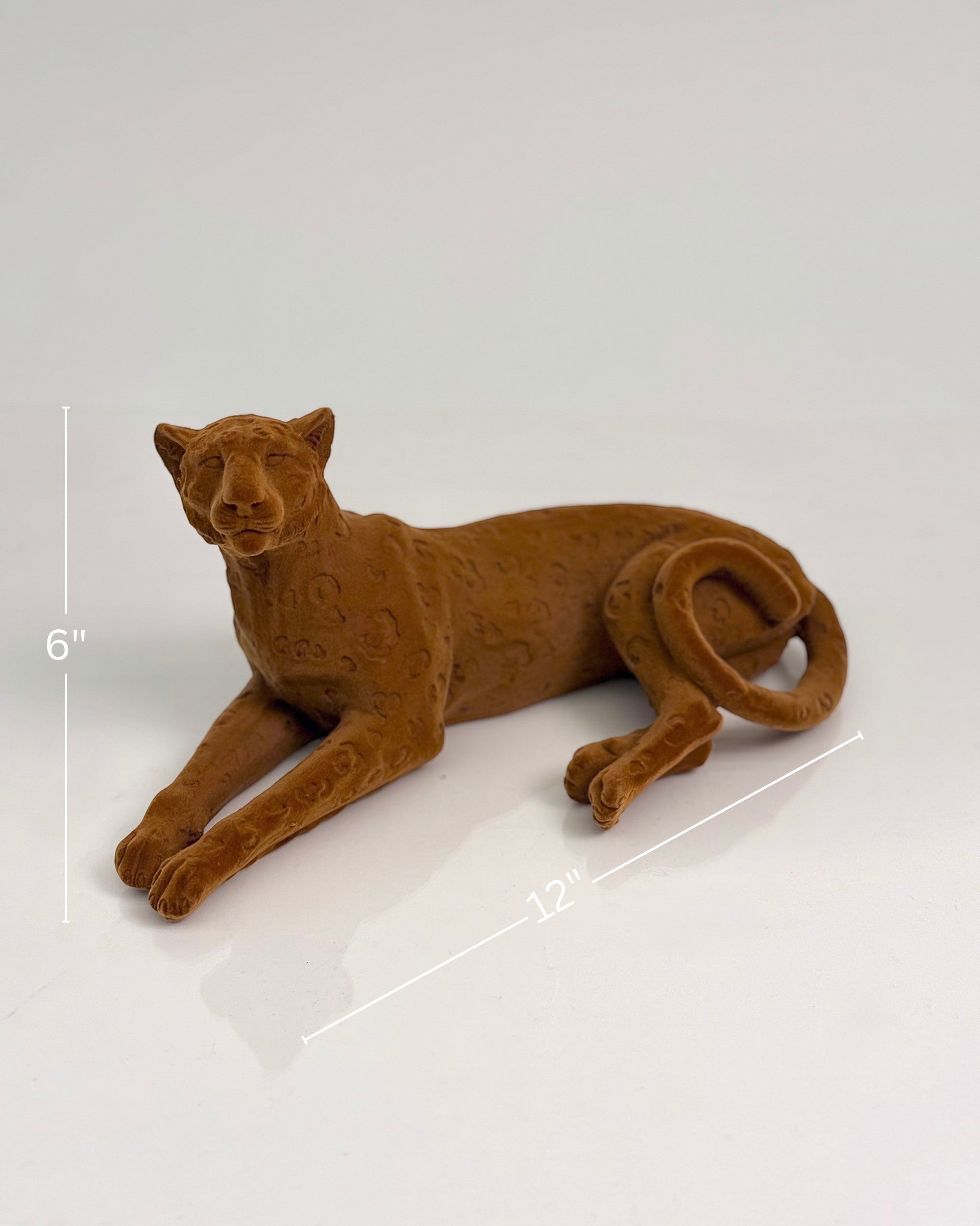 High Objects terracotta cheetah sculpture with carved detailing, lying down. 12" L x 6" H.