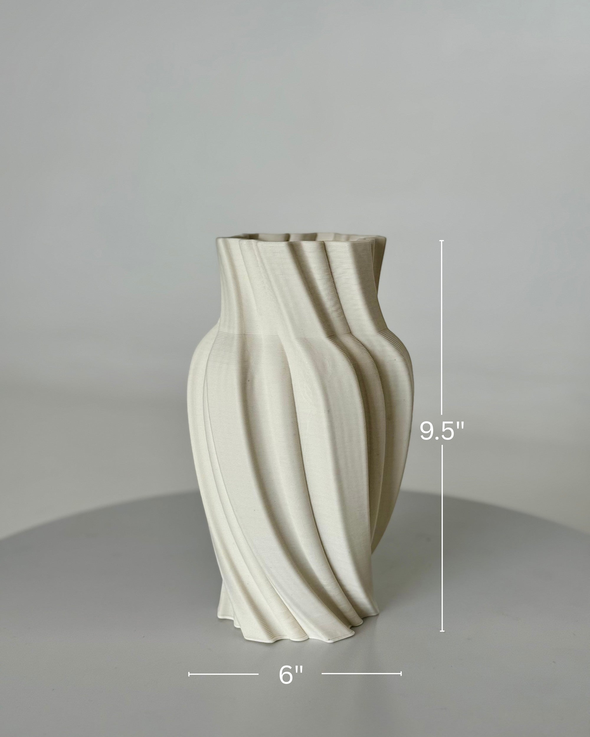 High Objects Volara Vase, a 9.5" tall ceramic vase with a matte off-white finish and a unique twisted, fluid design.