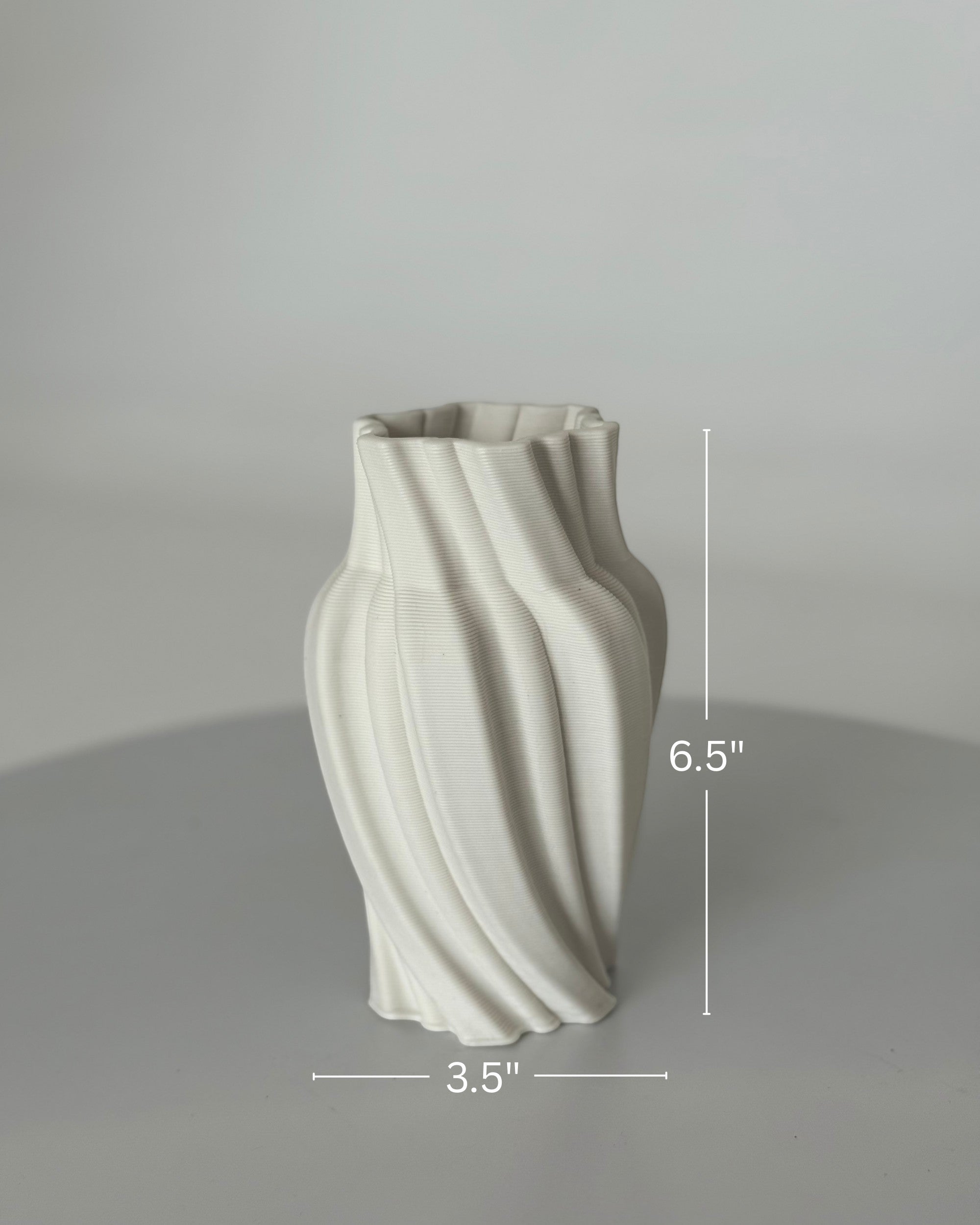 High Objects Volara Vase, white ceramic, 6.5" tall, 3.5" wide, with a twisting, fluid design.