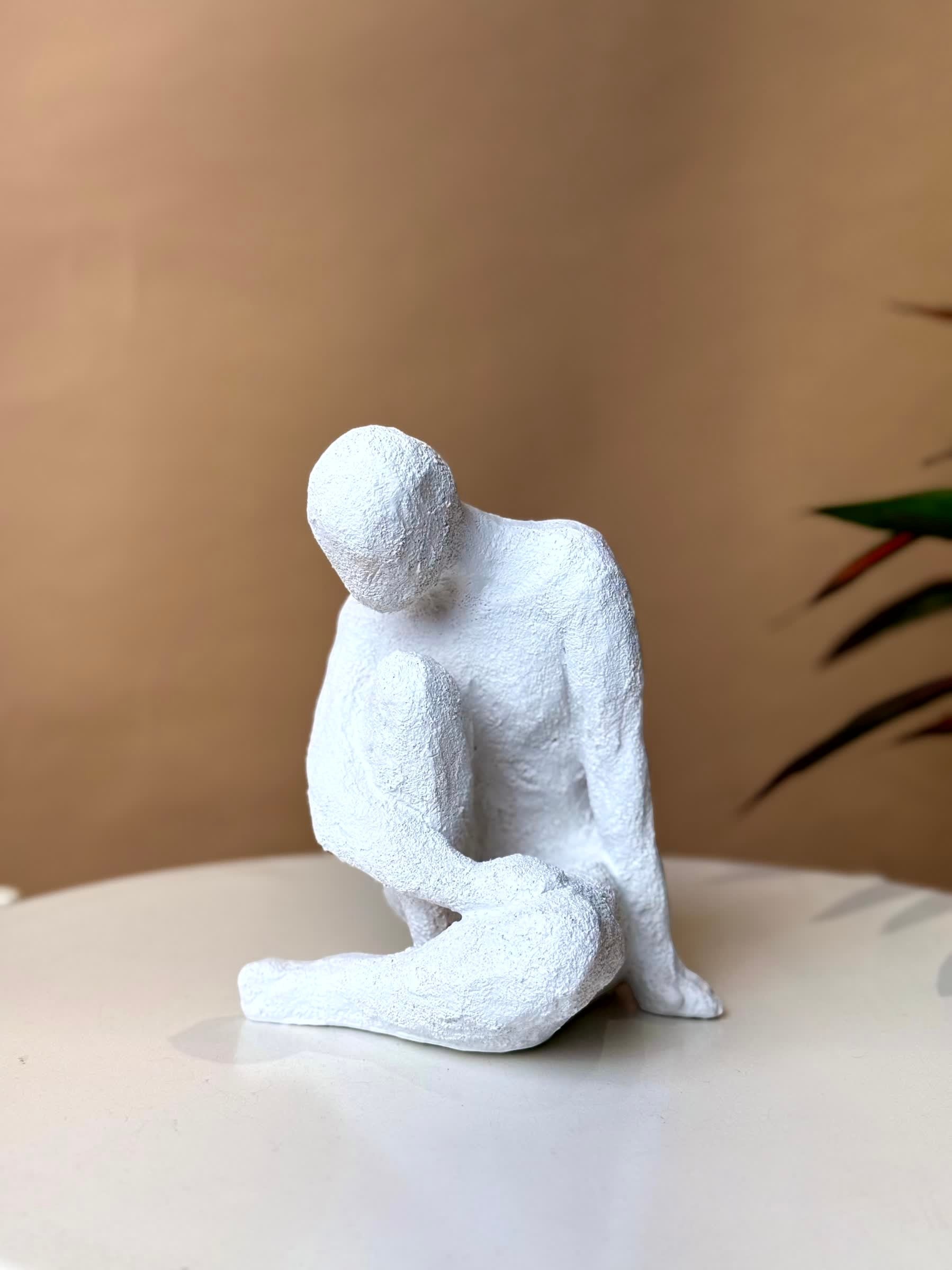 High Objects white textured polyresin abstract faceless figure in a contemplative pose, 8.5-inch sculpture.