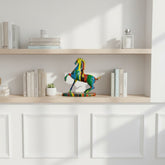 High Objects colourful abstract horse sculpture with vibrant paint strokes on a decorative base, displayed on a shelf.