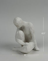 High Objects textured white polyresin abstract faceless figure sculpture, 8.5 inches tall, in a contemplative pose.