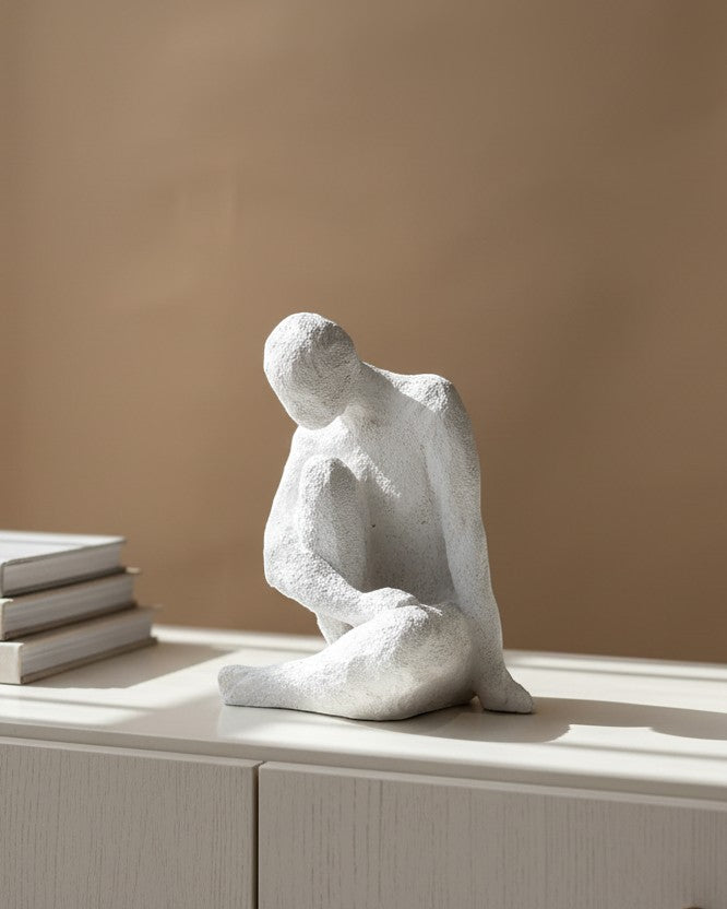 High Objects white textured polyresin abstract faceless figure sculpture in a contemplative pose.