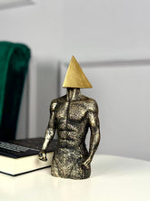 High Objects abstract sculpture of a muscular torso with a gold triangle head, textured stone finish.