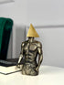 High Objects abstract sculpture of a muscular torso with a gold triangle head, textured stone finish.