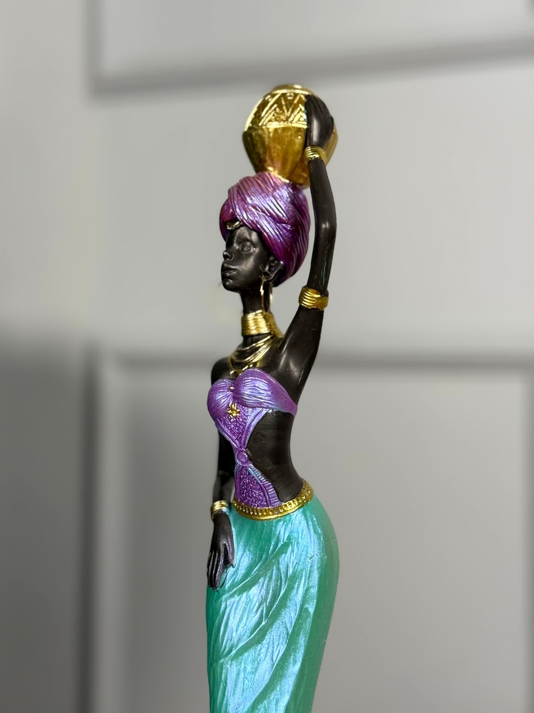 High Objects African Lady Elegance showpiece sculpture in turquoise, violet, and gold, holding a pot on her head.